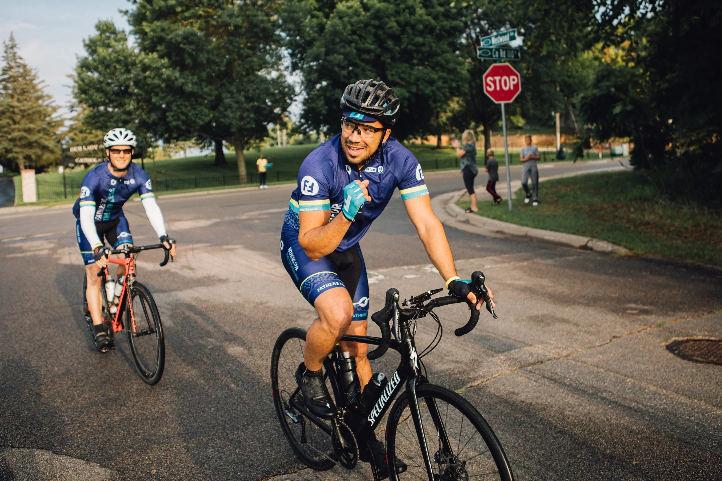 two men on bikes at race smiling