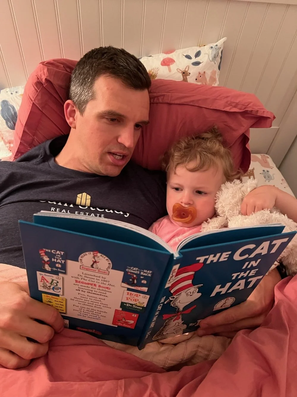 dad reading to child in bed