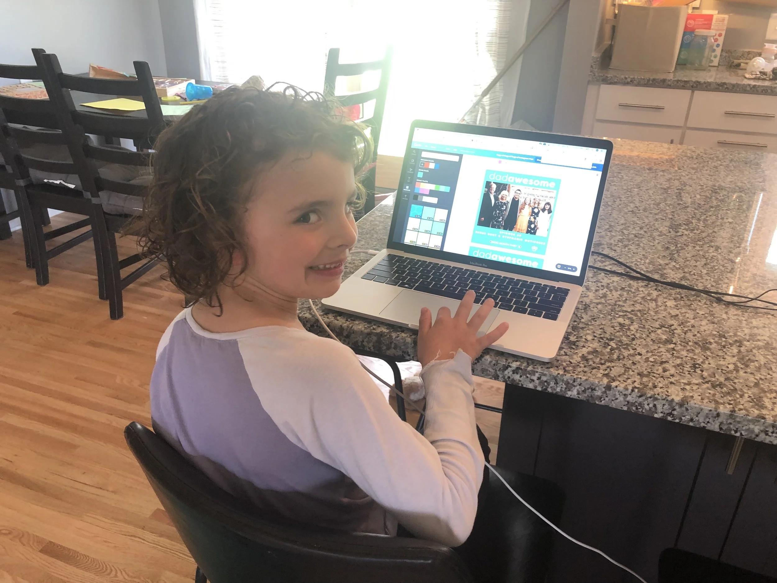 kid smiling with computer