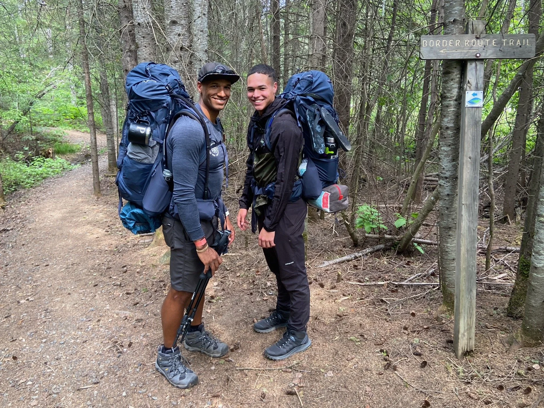 two dads smiling on a hike