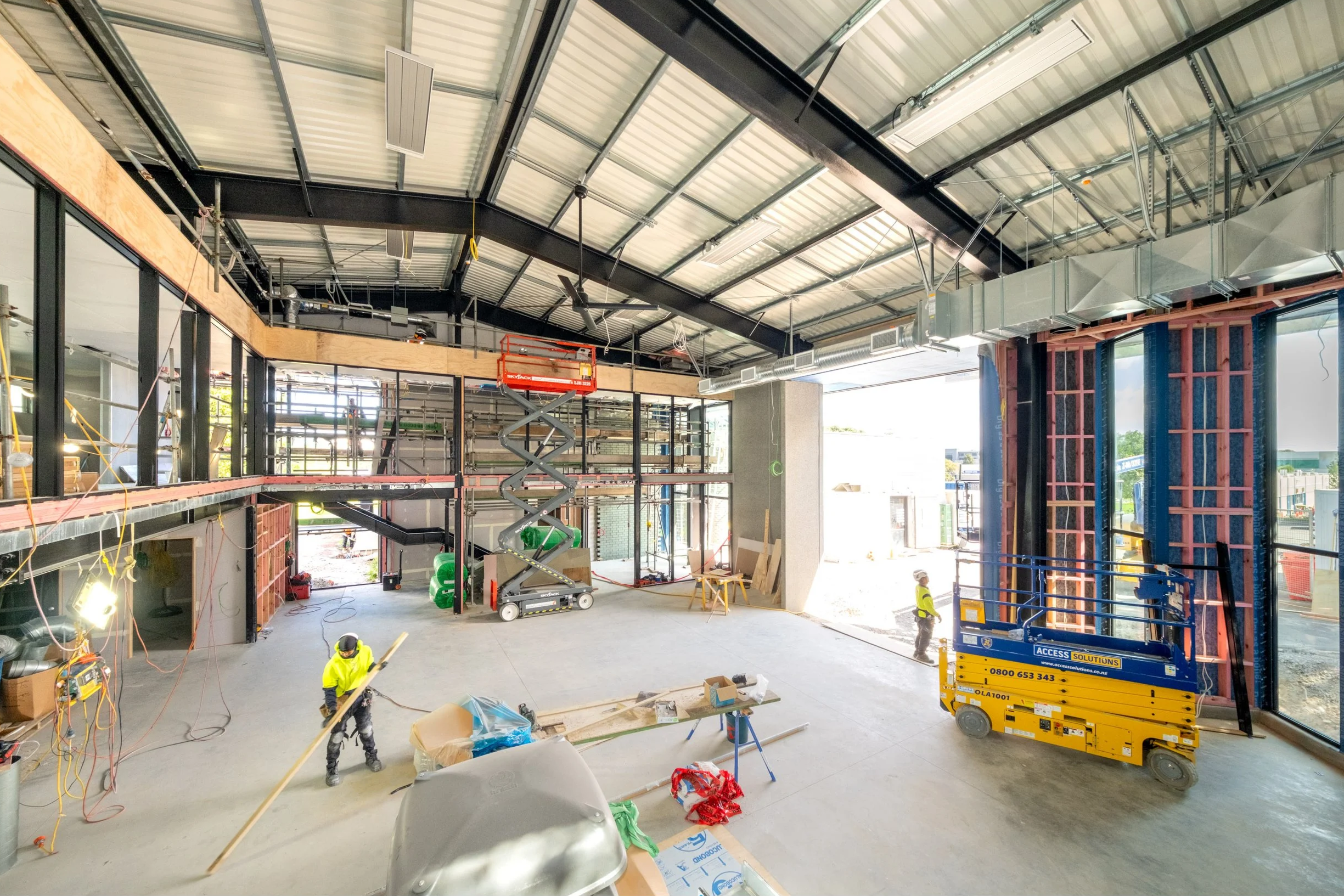 Active construction site interior showing exposed structure, services, and ongoing works, illustrating the complexity and coordination involved during construction.