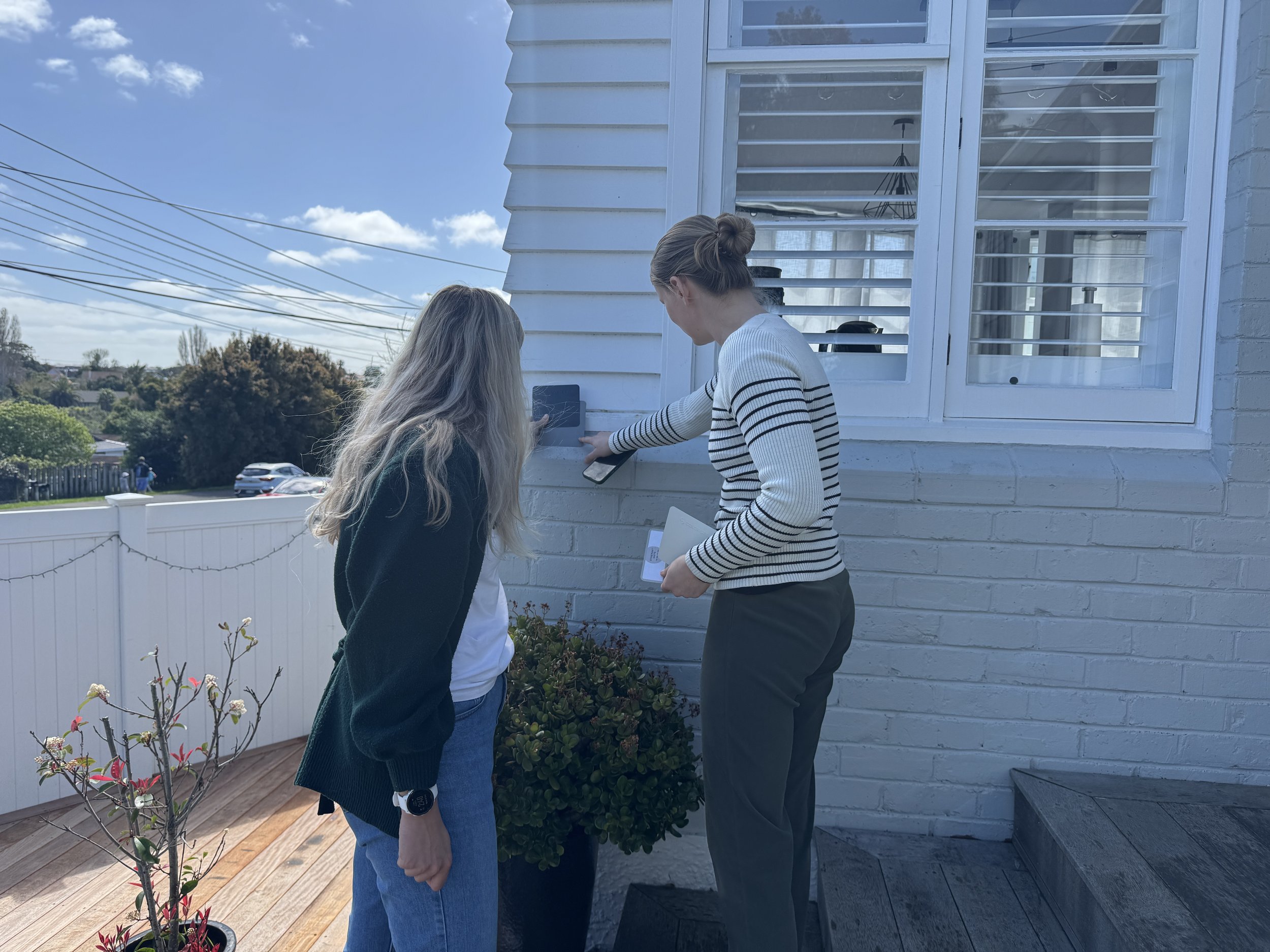 Architect and client reviewing material and colour options together at an existing home, supporting an informed and collaborative design process.