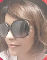 A woman with shoulder-length hair wearing large, dark sunglasses.