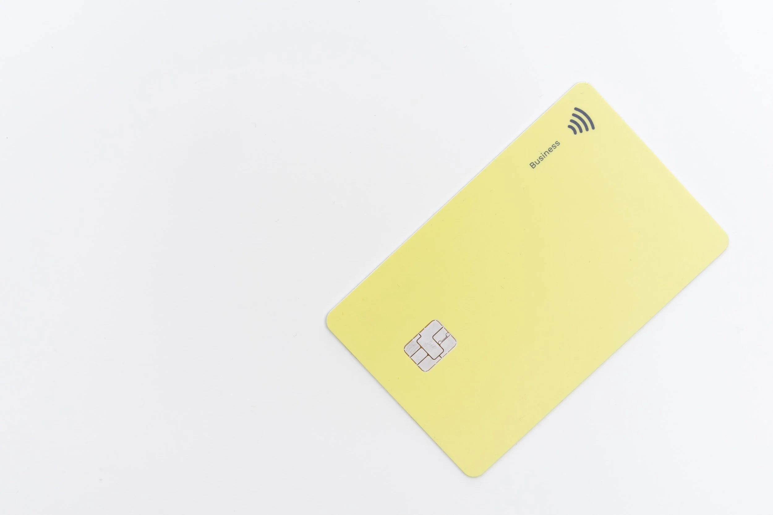 A yellow business SIM card with a contact chip on a white background.