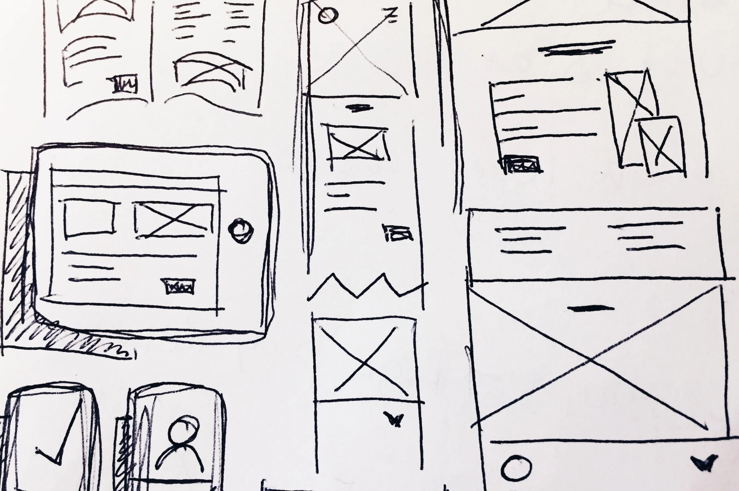 Sketches of various mobile app and web page layouts, including wireframes with placeholder images, text, and navigation elements.