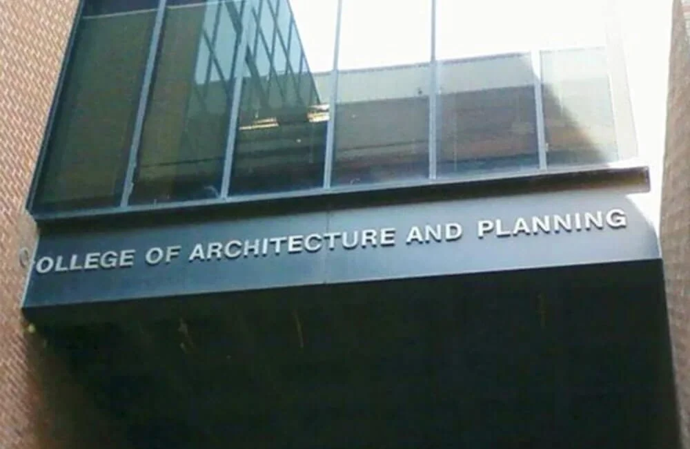 Sign reading 'College of Architecture and Planning' on a building.