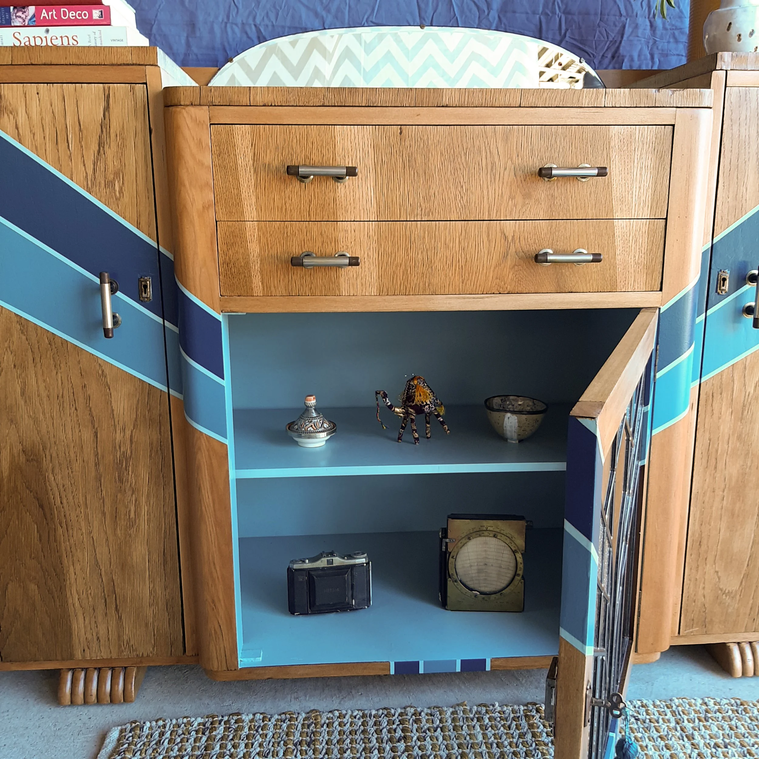 Upcycled art deco sideboard cabinet with mirror and a new customised leadlight front designed and made by me. Built new leadlight panel for the front middle cabinet, sanded off old shellac, painted new design, varnished