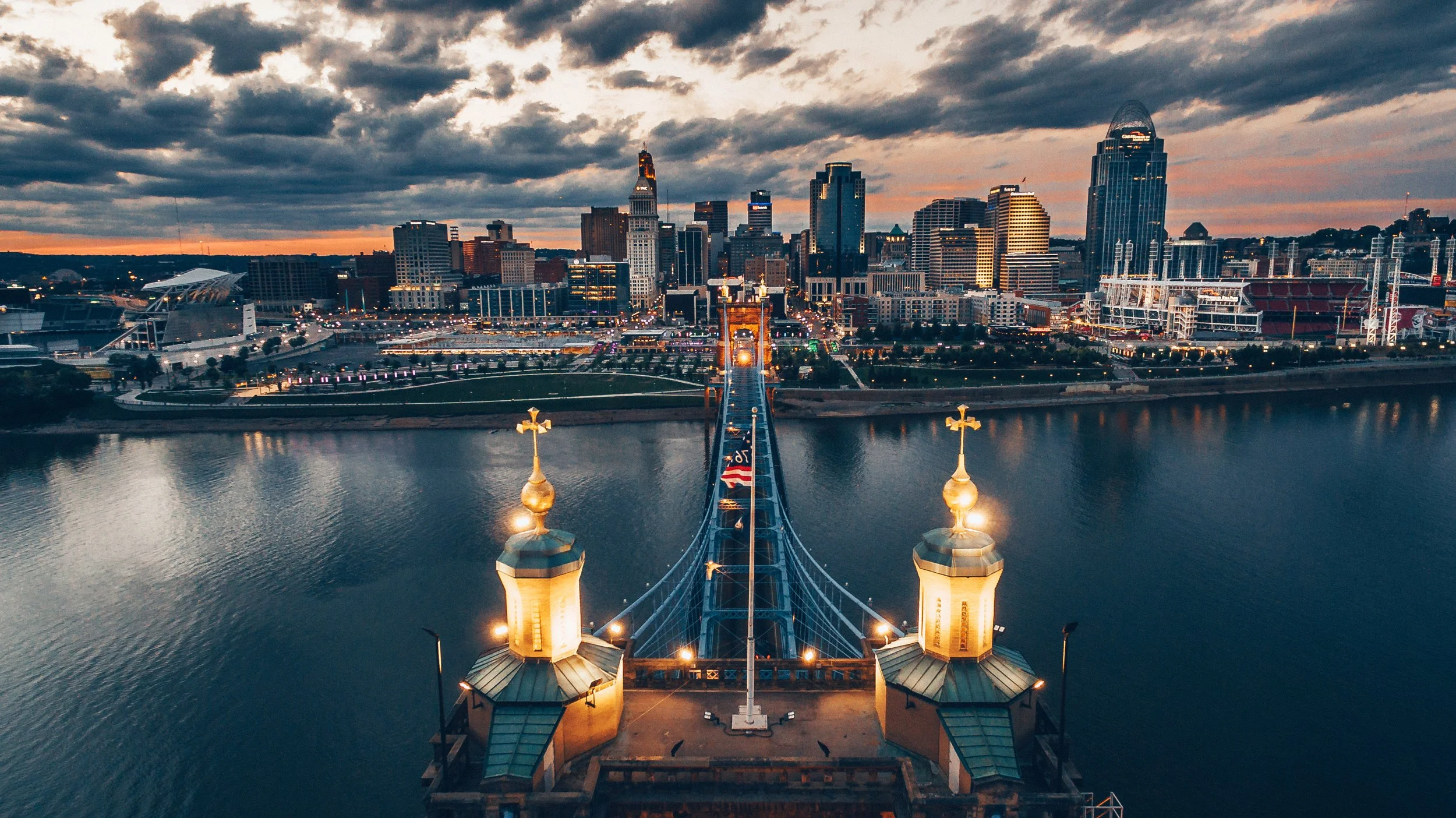 Cincinnati skyline above the Roebling Bridge as the sun is setting