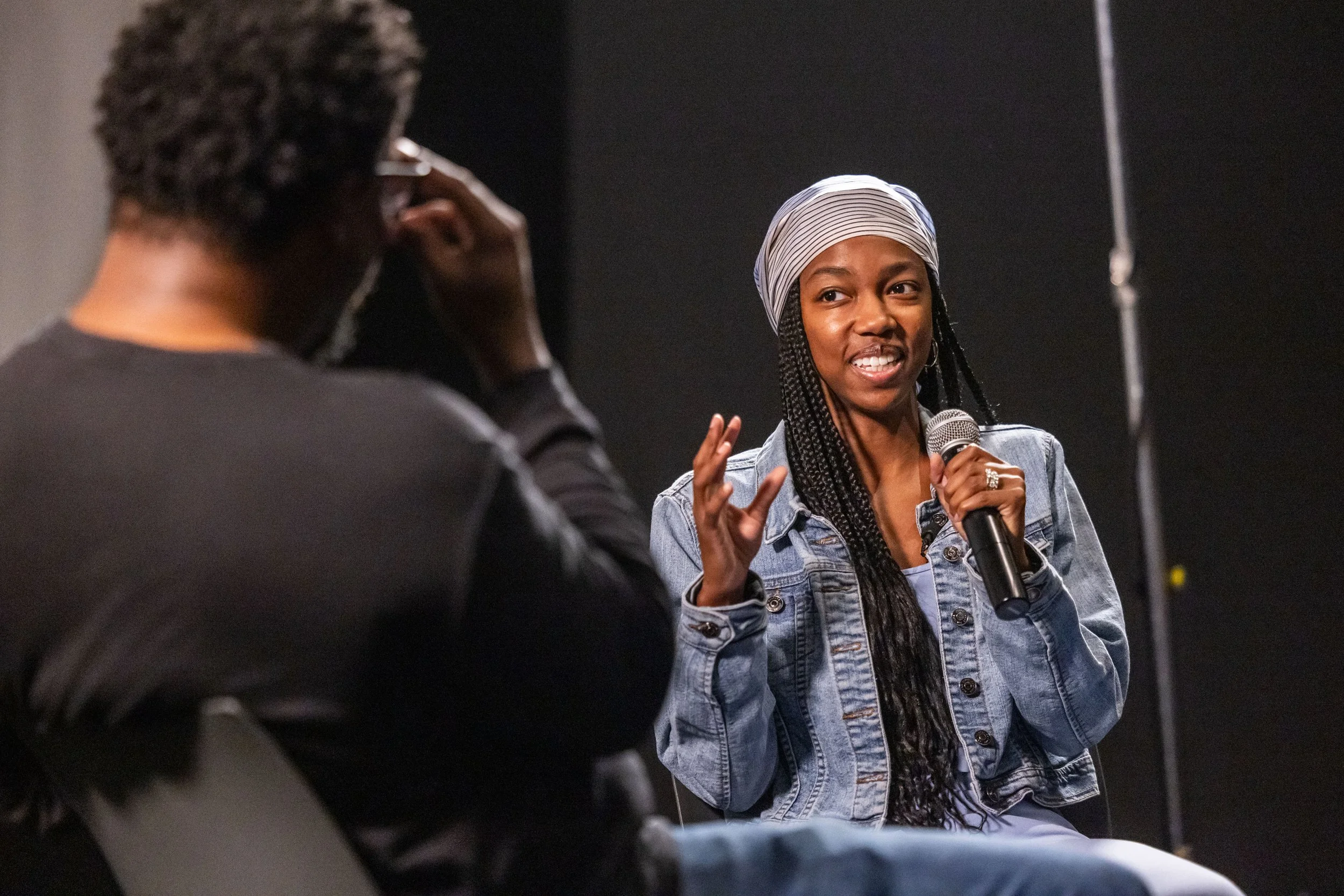 Woman smiling as she sits across a man to discuss her film that screened at the festival