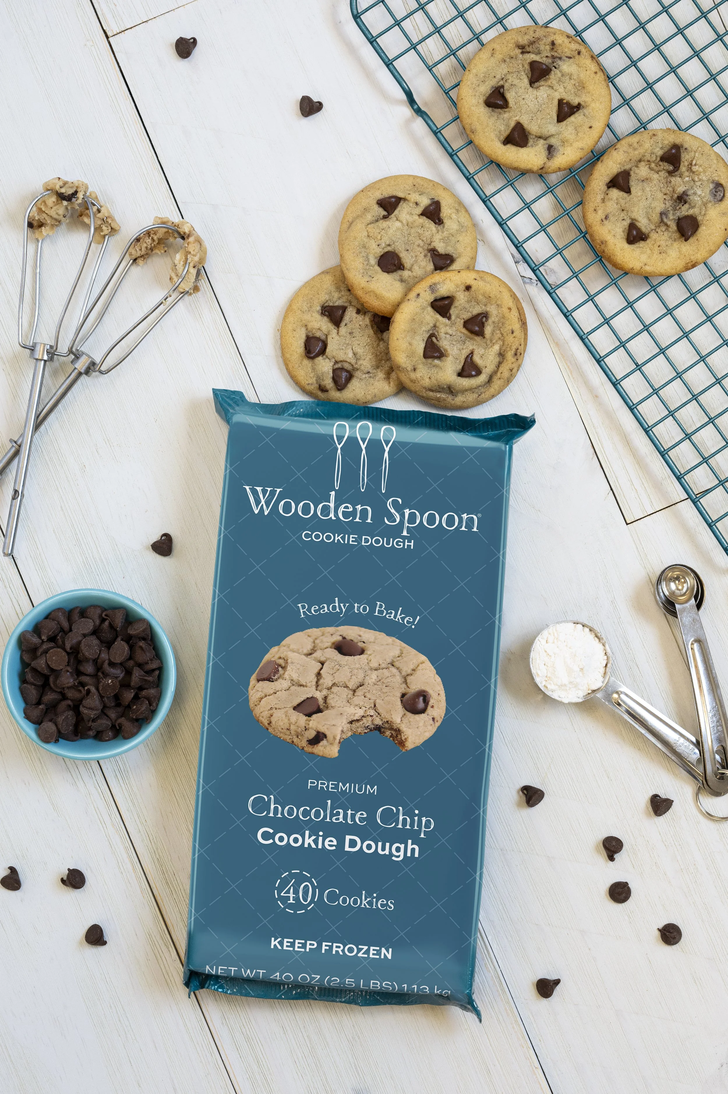 Baking ingredients surround a package of Chocolate Chip cookie dough