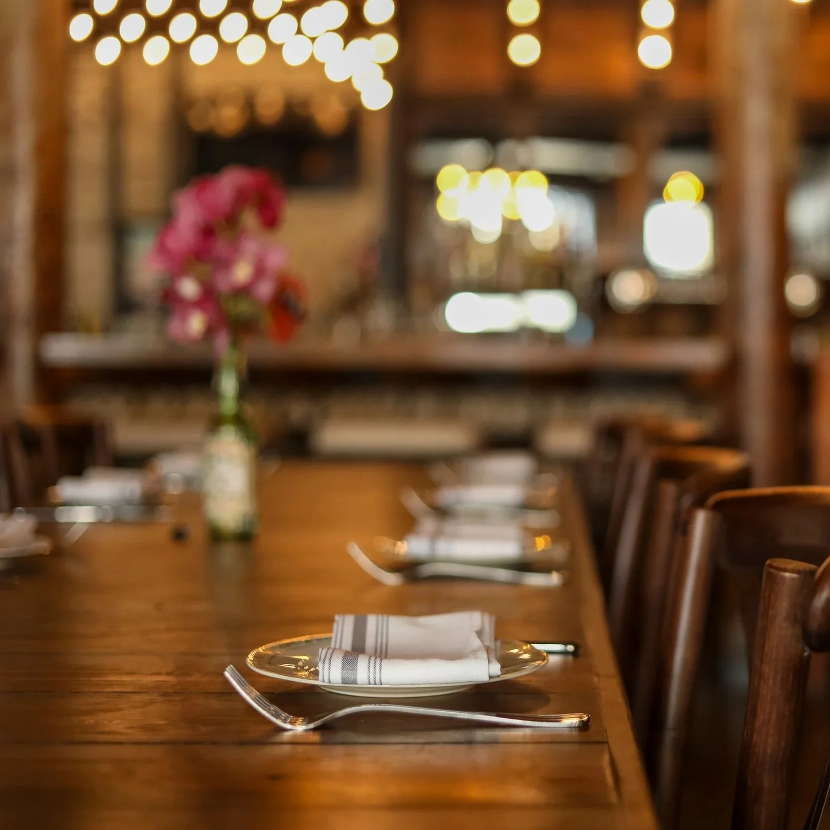 Warm dining room interior at Plates Restaurant in the New Orleans Warehouse District with high ceilings and original wood