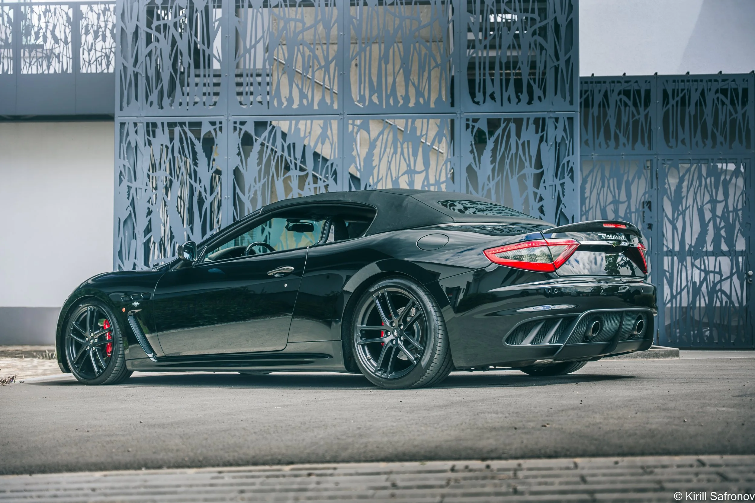 Black Maserati GranTurismo in Front of Modern Architecture
