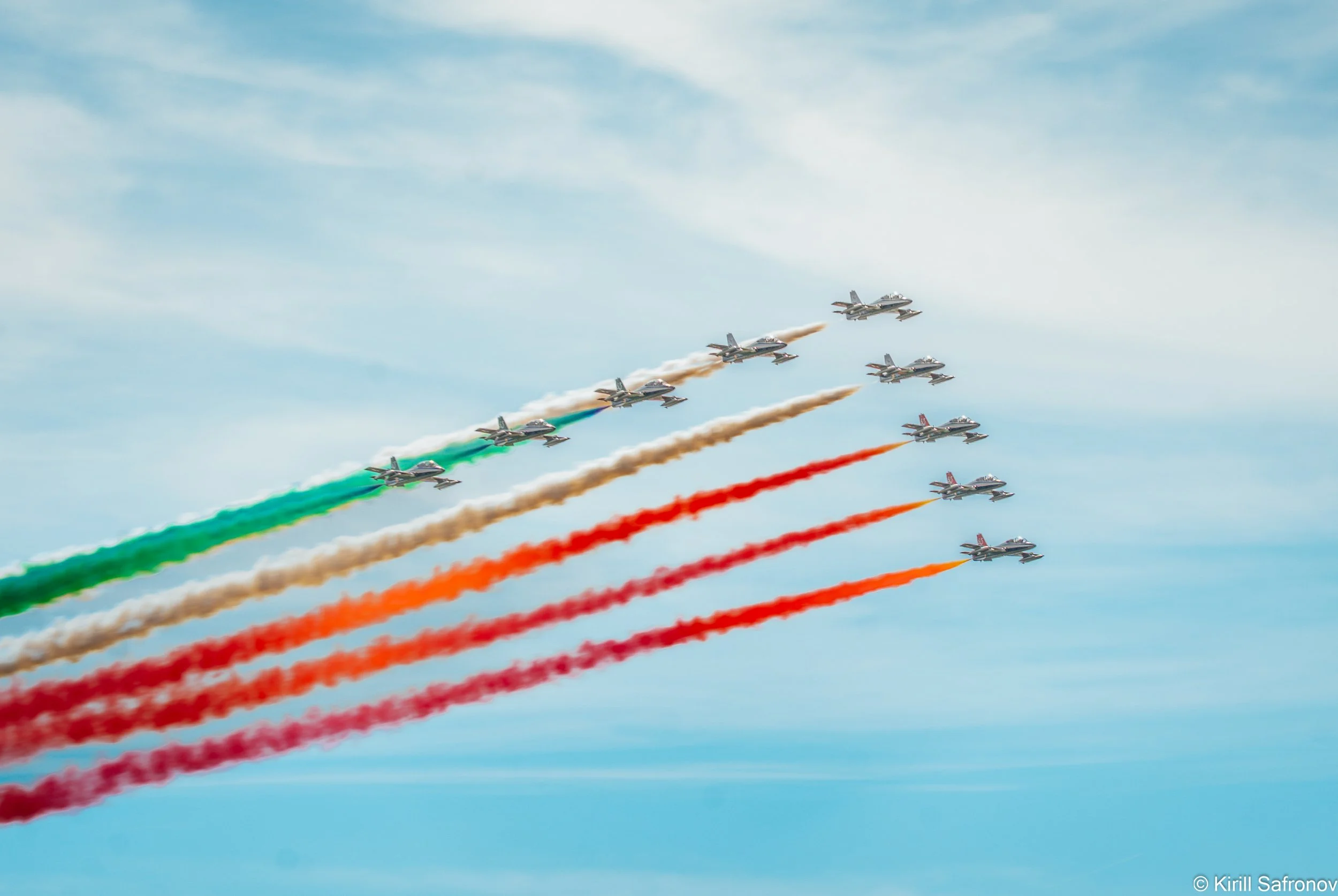 Photo of fighter jets flying in formation across the sky, leaving green, white, and red smoke trails that represent the Italian flag during F1 Monza GrandPrix