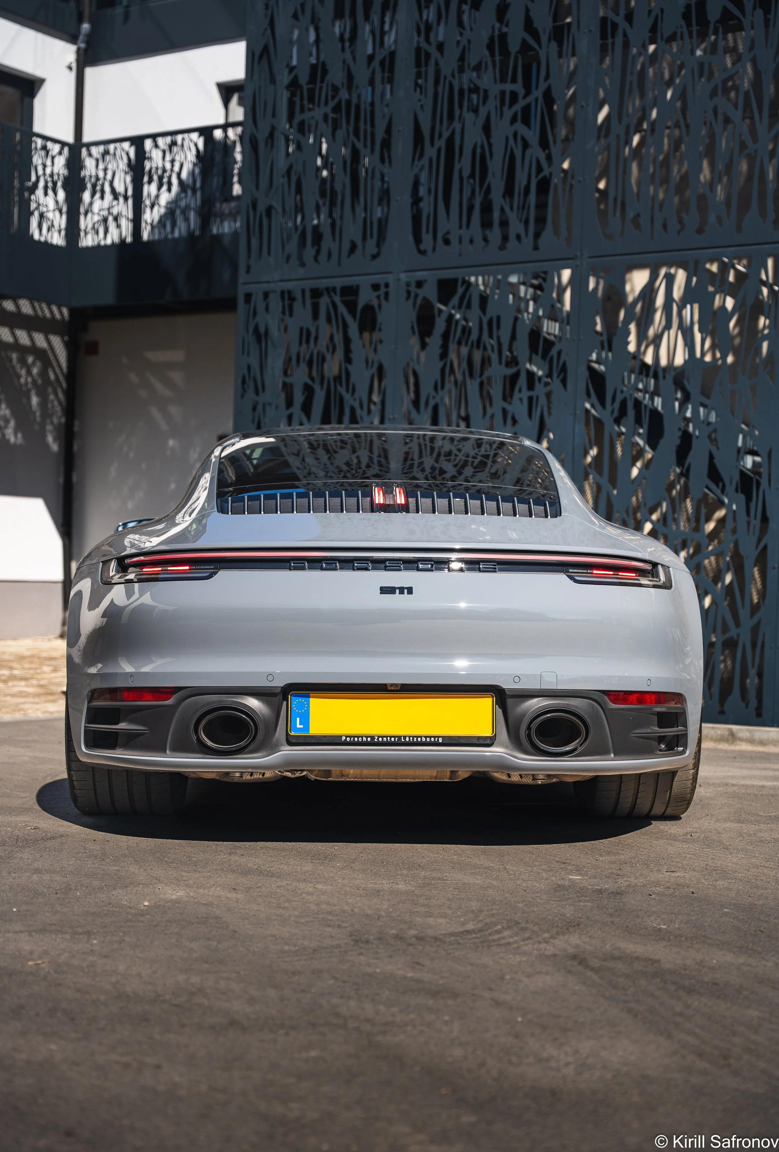 Gray Porsche 911 Carrera 4S in Sunny Urban Setting