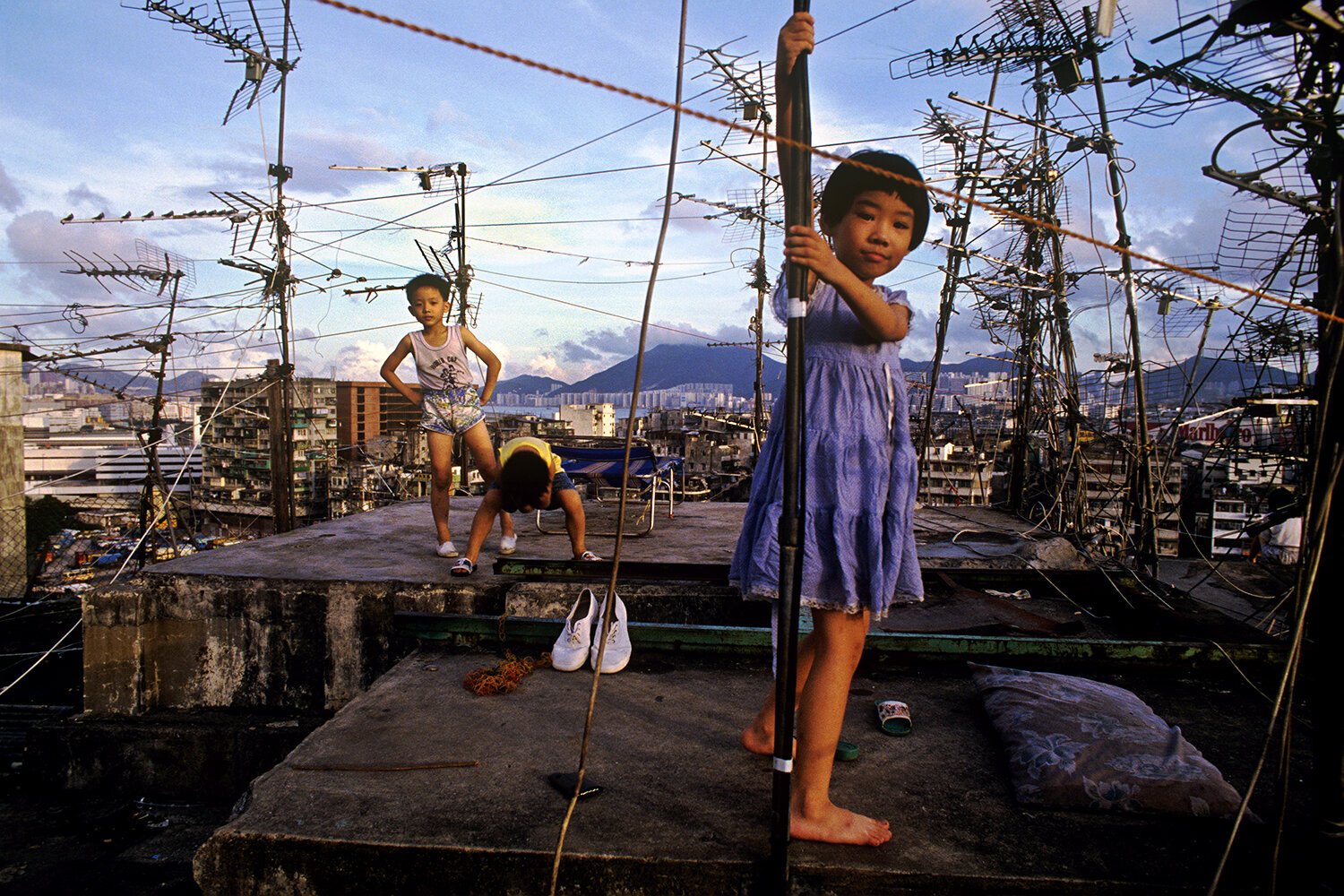 "Kids on Kowloon Walled City Rooftop. 1990" from the Series “City of Darkness Revisited” by Greg Girard | Canon F-1, Fujichrome Provia Film