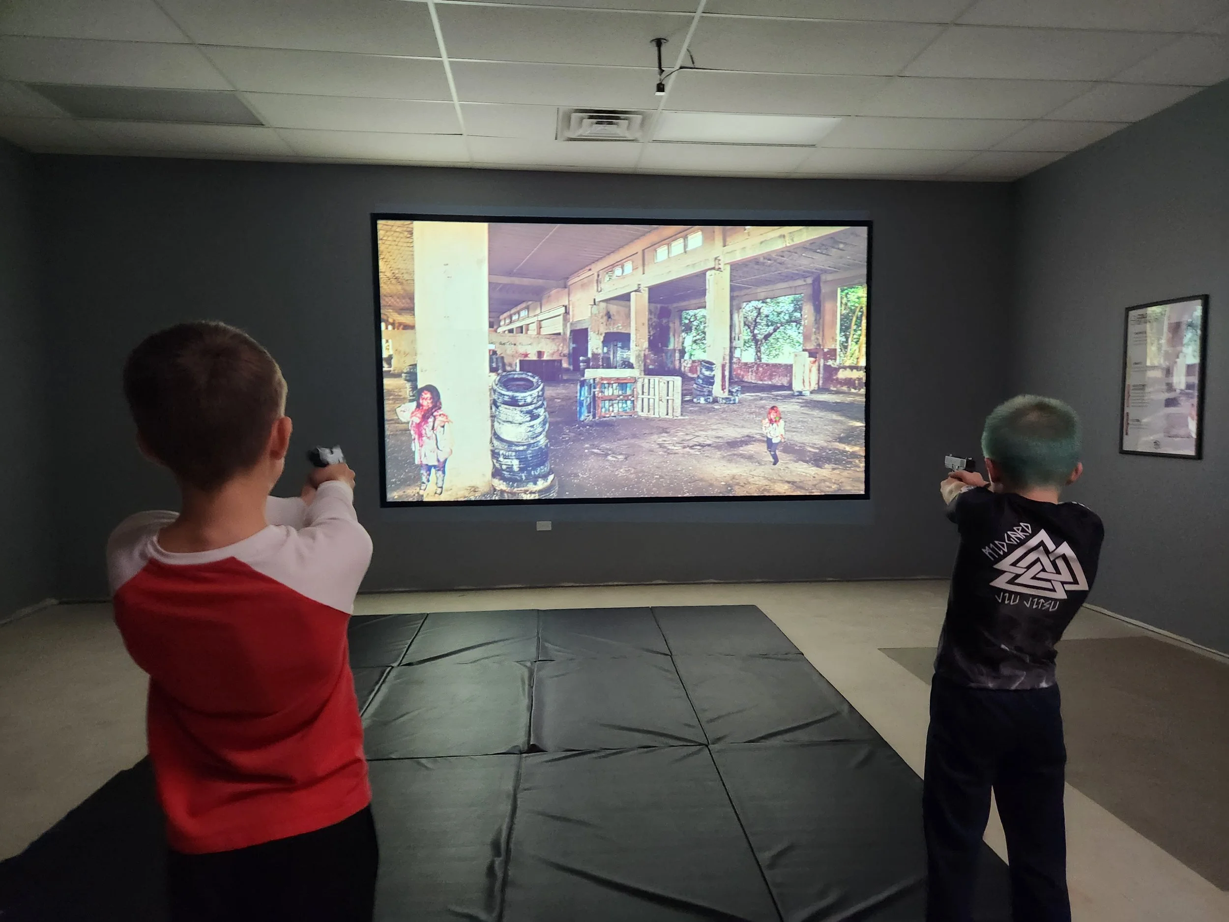 Two young boys practicing on virtual range - Zombie Shoot