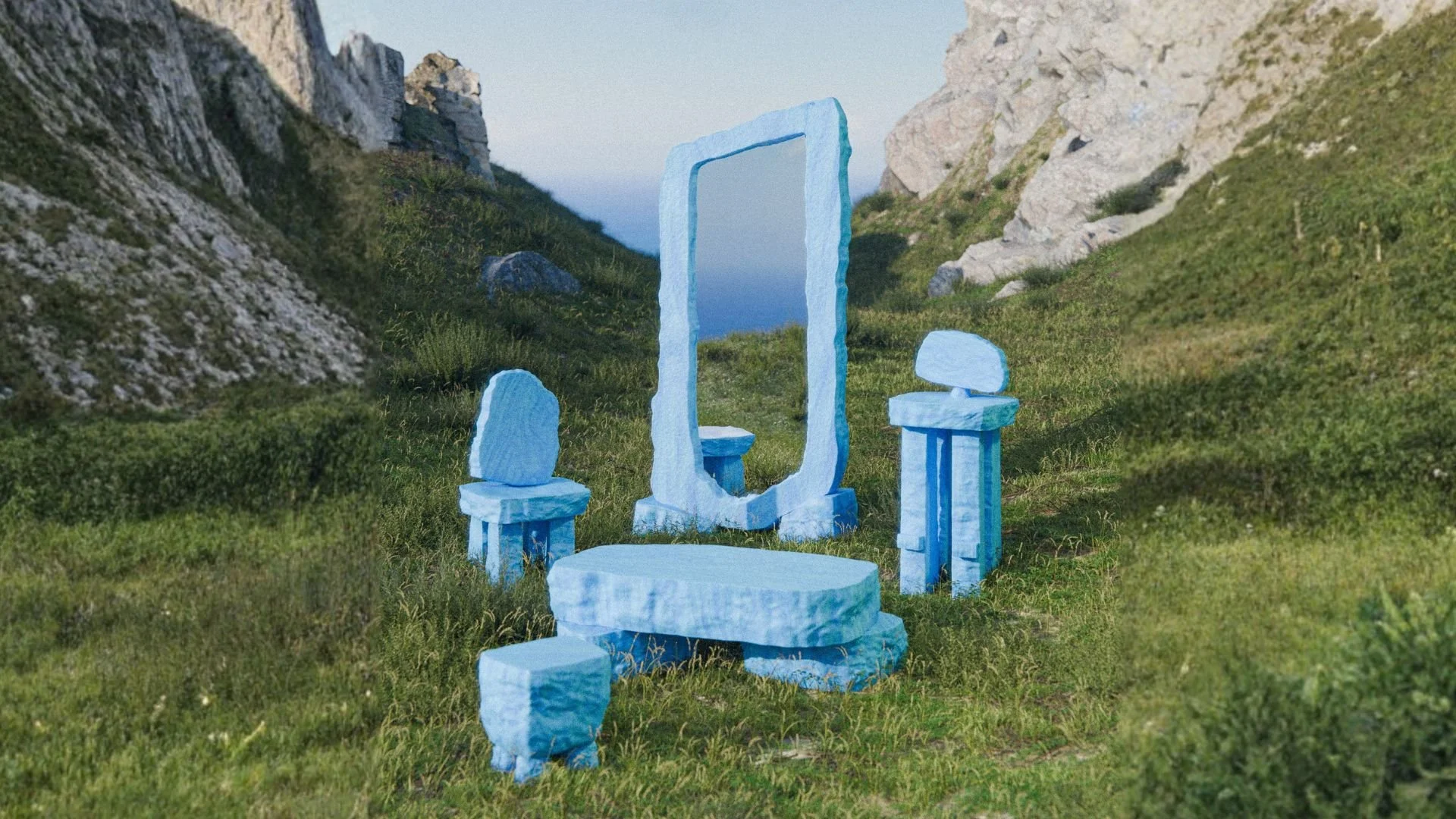 An outdoor sculpture installation resembling a bathroom setup with light blue stone-like structures, including a mirror, a bathtub, two stools, and other fixtures, in a grassy valley surrounded by mountains.
