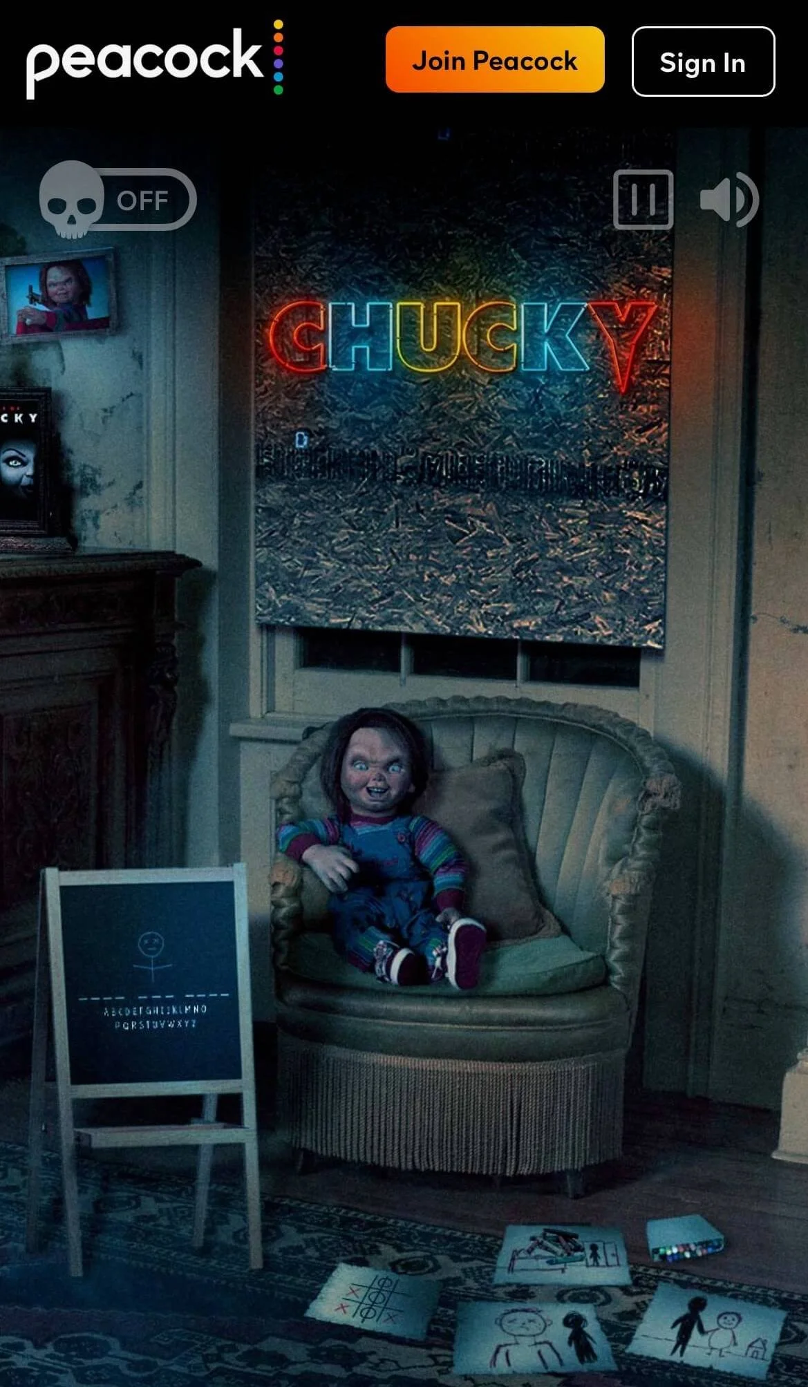 A room with a Chucky doll sitting on a vintage armchair, a neon sign reading 'CHUCKY' on the wall, a gaming board on an easel, children's drawings and toys on the floor, and a framed picture on a shelf, with dark lighting.