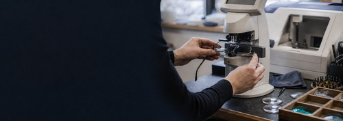 An optical professional checking prescription glasses using laboratory equipment
