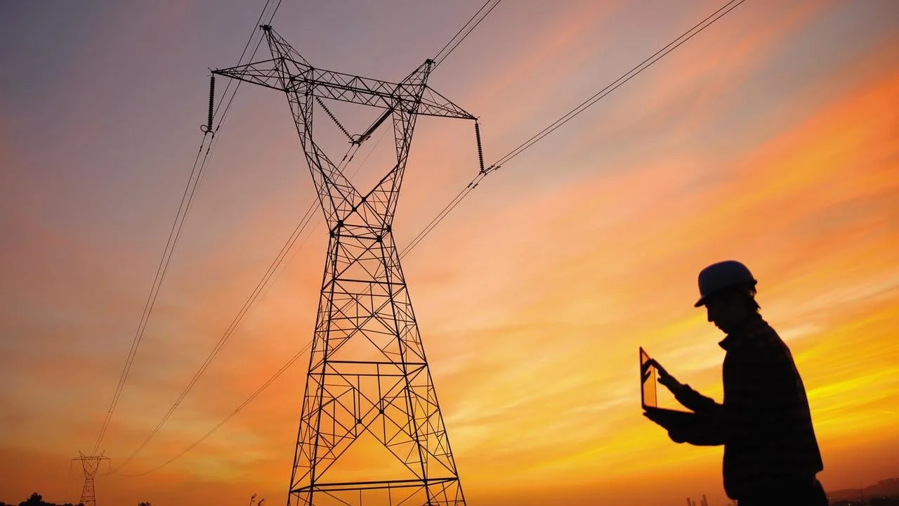 Man standing in front of large power cable unit