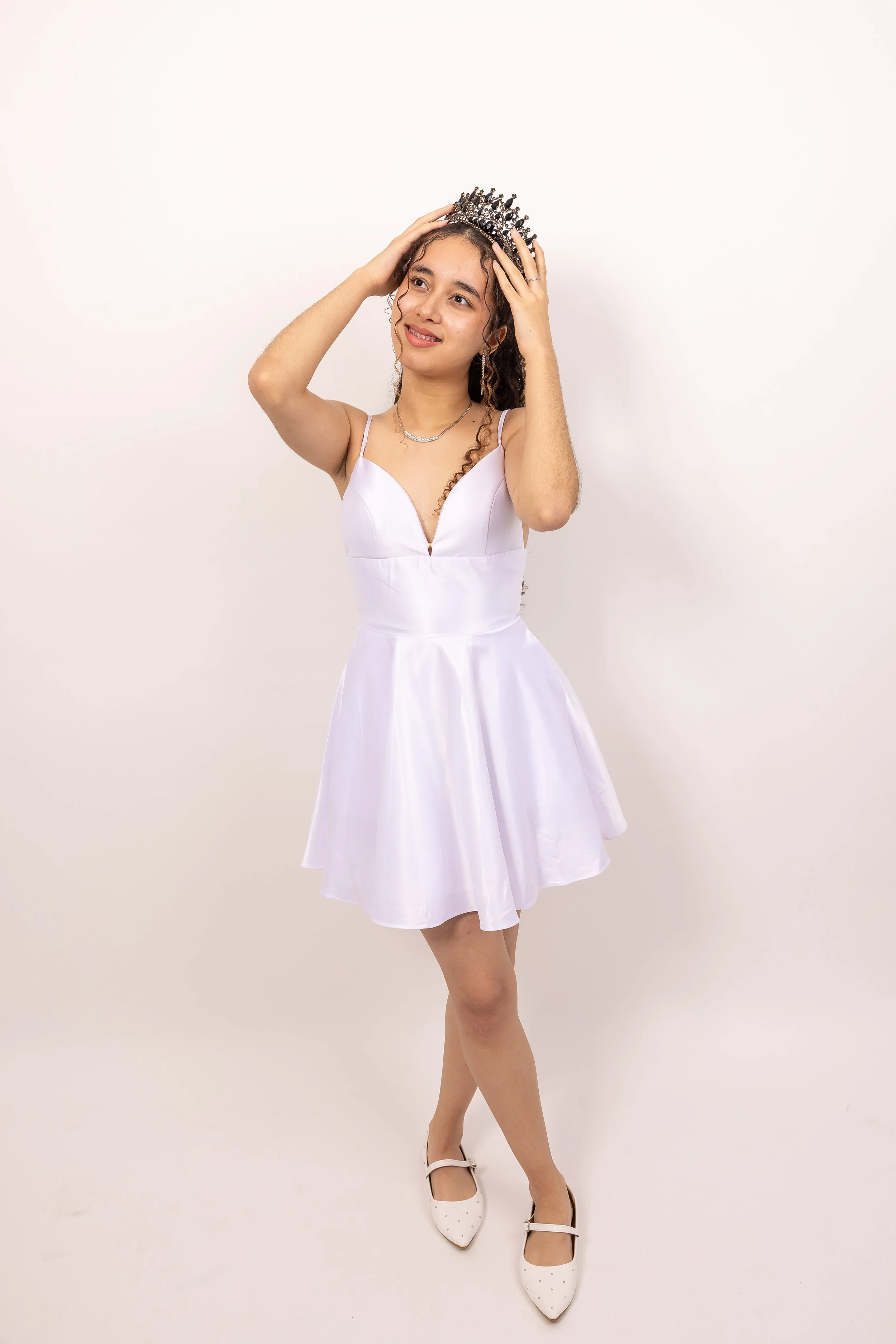 Juvenil con vestido blanco y corona en celebracion