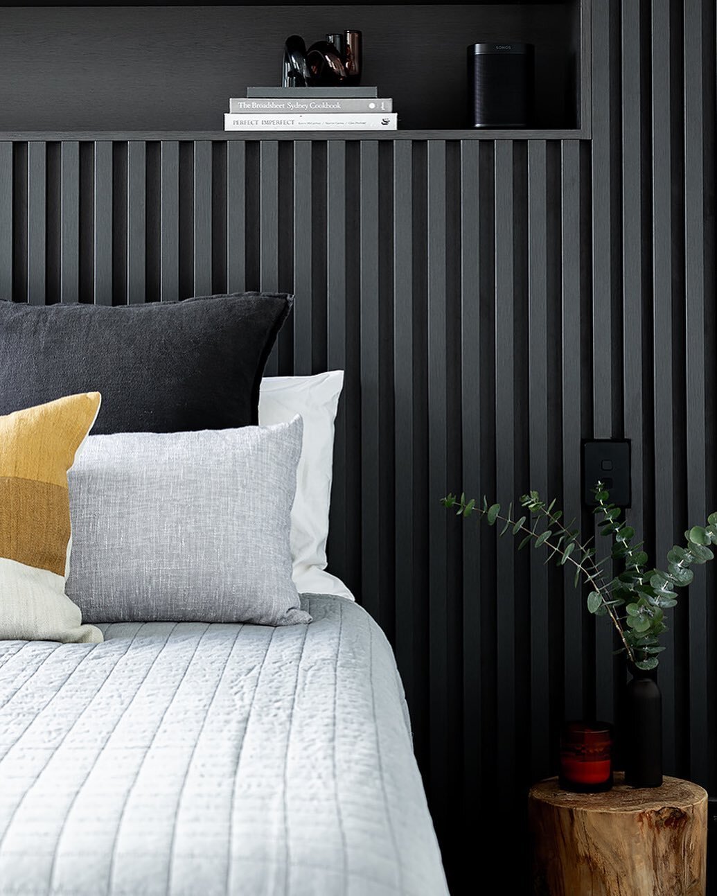 Bedroom details in our Darlinghurst project where a bespoke joinery bedhead creates a striking feature. The material palettes connects this space to the rest of the apartment while hidden storage, open shelves and integrated lighting makes this the p