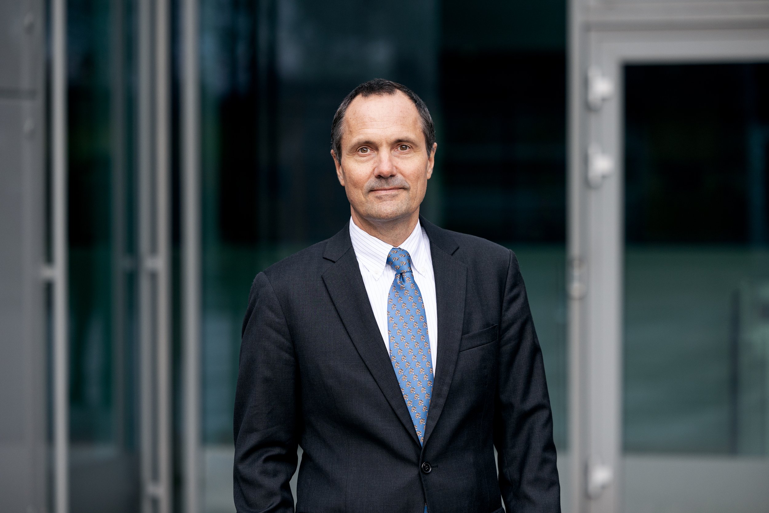 Man in suit in front of building