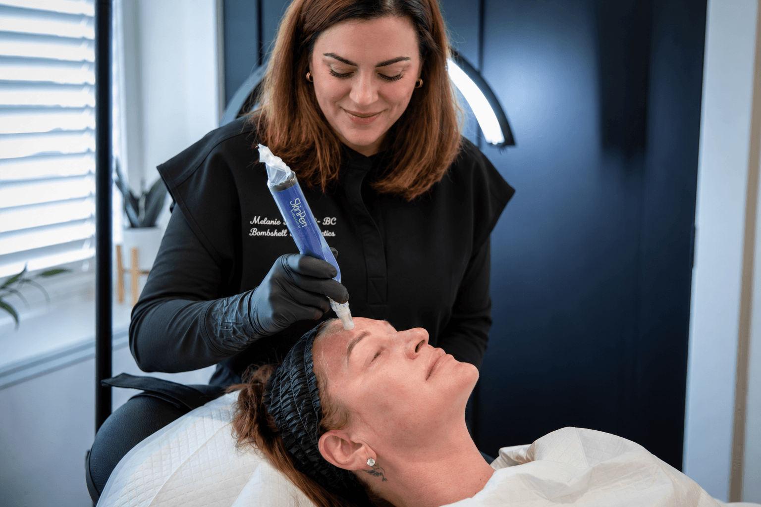 A Nurse Practitioner performing a Microneedling treatment  on a woman, at Bombshell Aesthetics in Bedford, NH