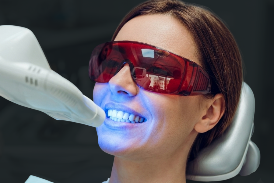 woman receiving a teeth whitening treatment at bombshell aesthetics in Bedford NH