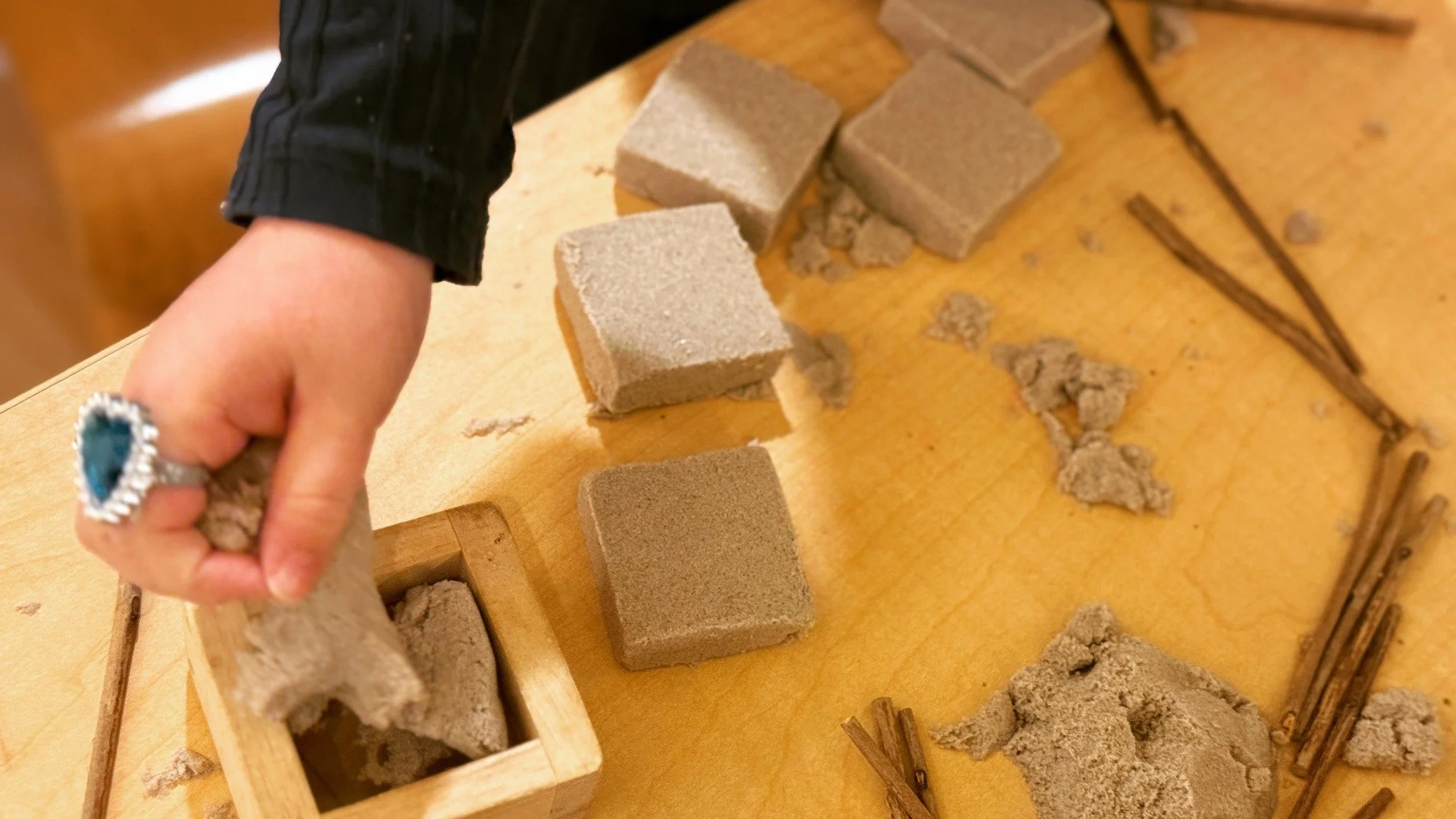 Working with versatile and malleable materials such as sand motivates the children to build, mold, and change course swiftly as they build. Pairing this with simple shape blocks and sticks, Room 8 children [4 year-olds] work together to transform the