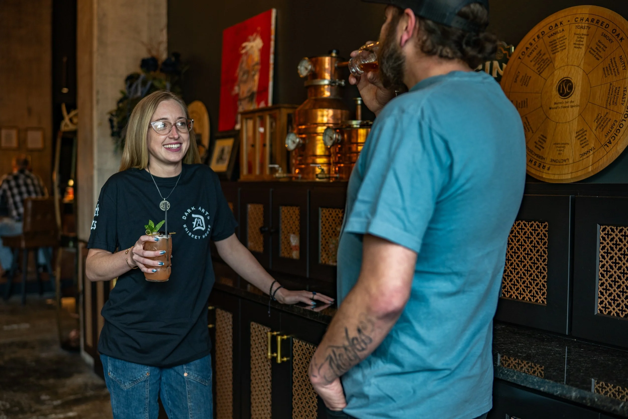 Guests enjoying handcrafted cocktails and whiskey at Dark Arts Whiskey House in Lexington, Kentucky.