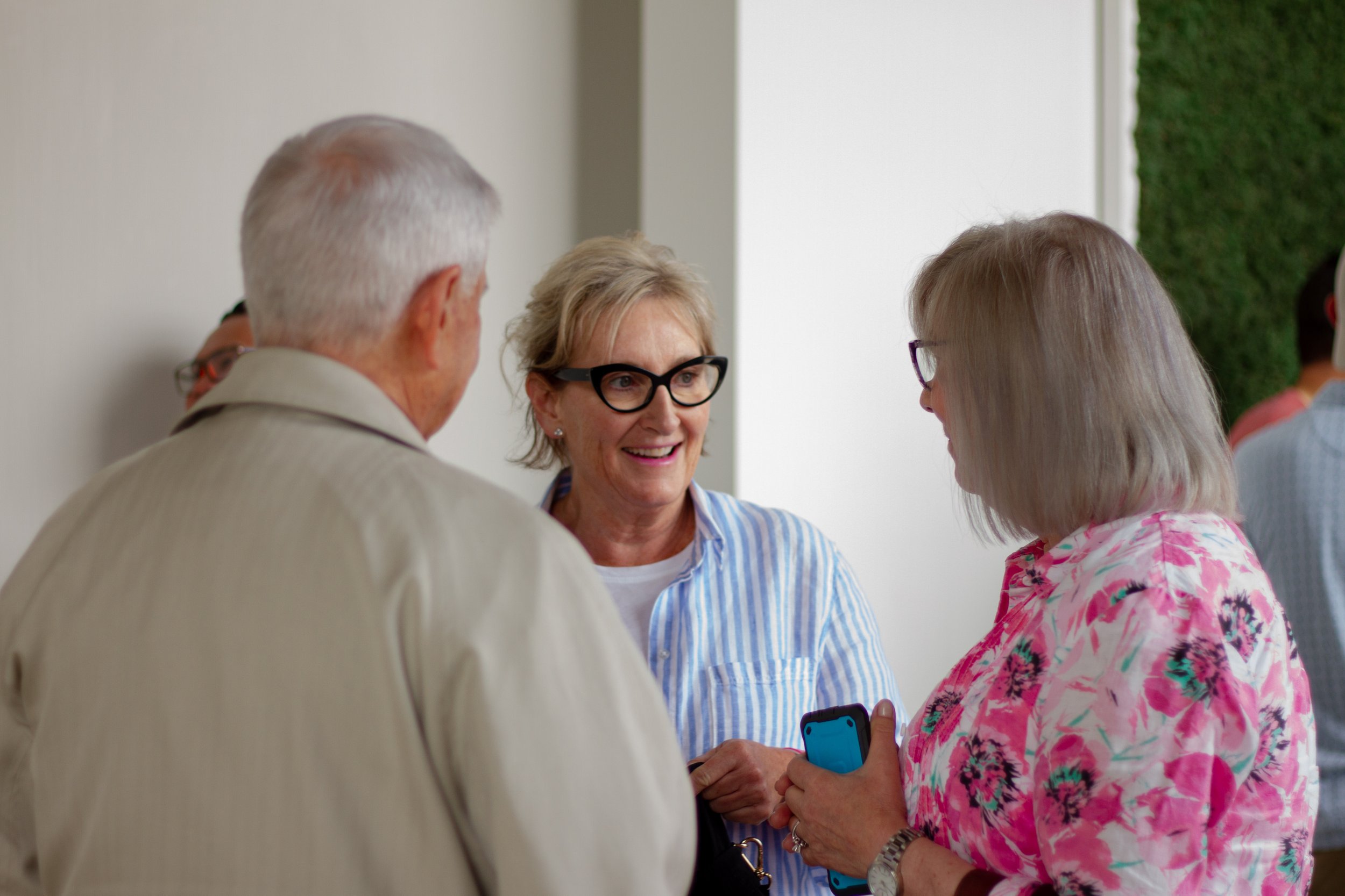 Older women smiling and talking at church
