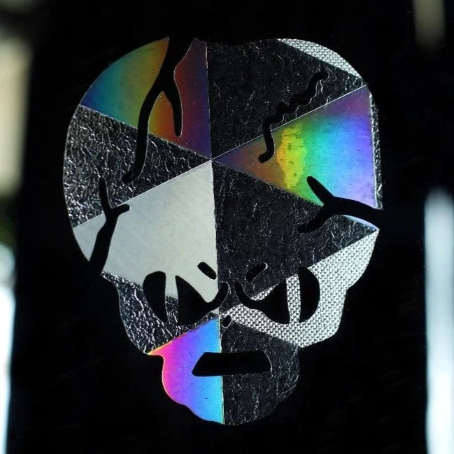 Reflective skull design with crackles and rainbow colors.