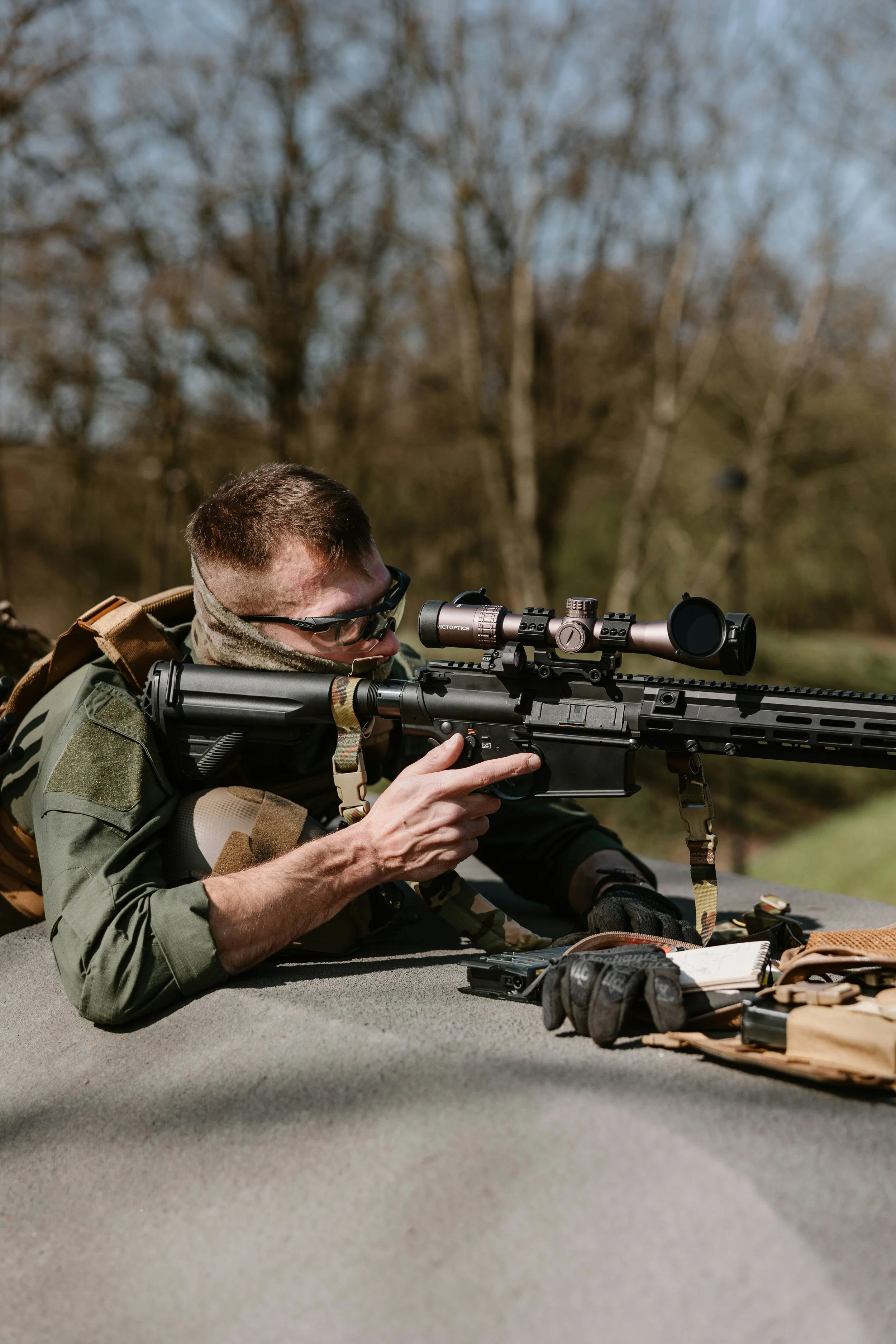 Shooter aiming a scoped PCP air rifle, available at Dive Outdoors in Redding, CA
