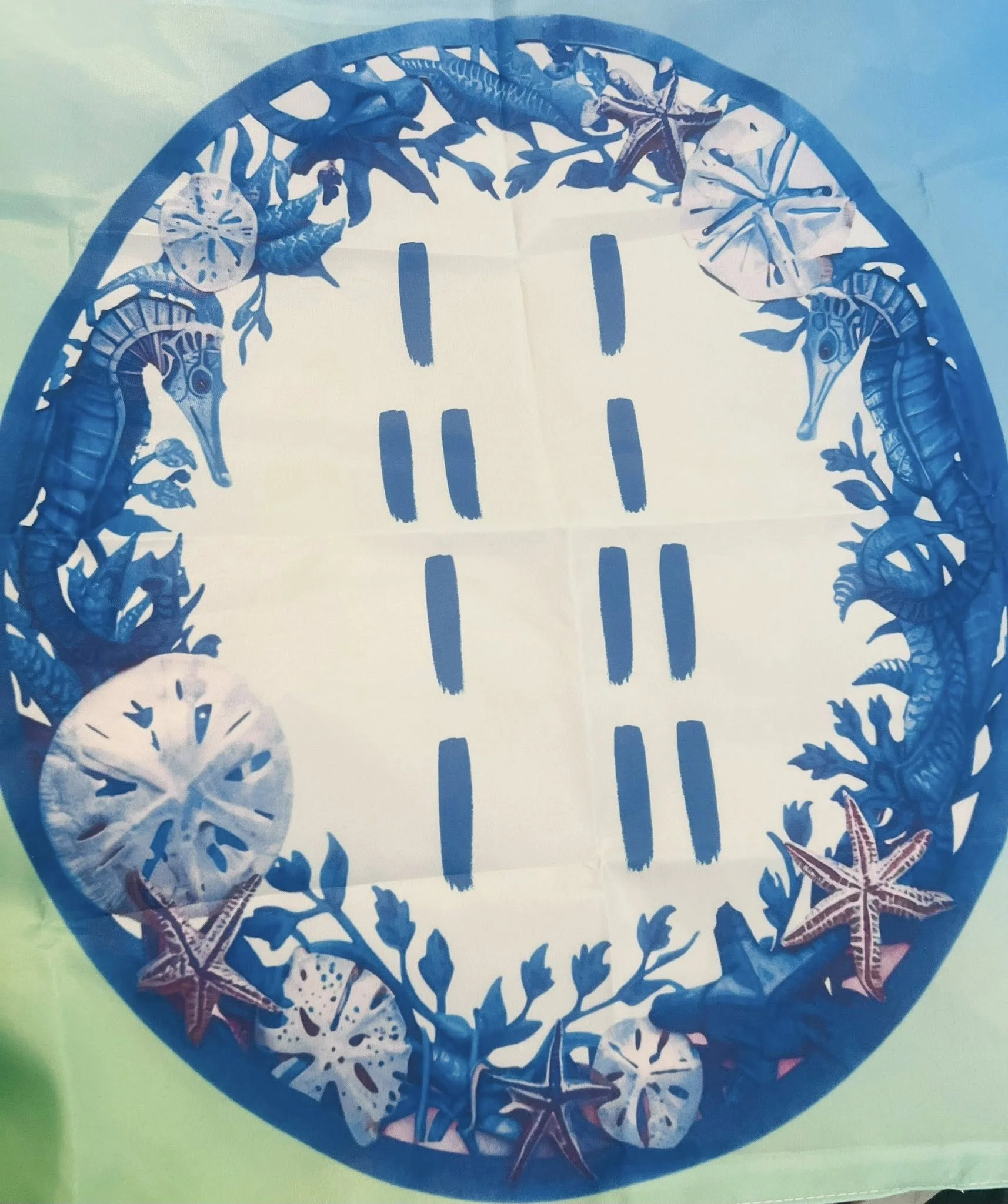 Decorative oval-shaped flag featuring blue sea creatures and starfish border, with odu marks.