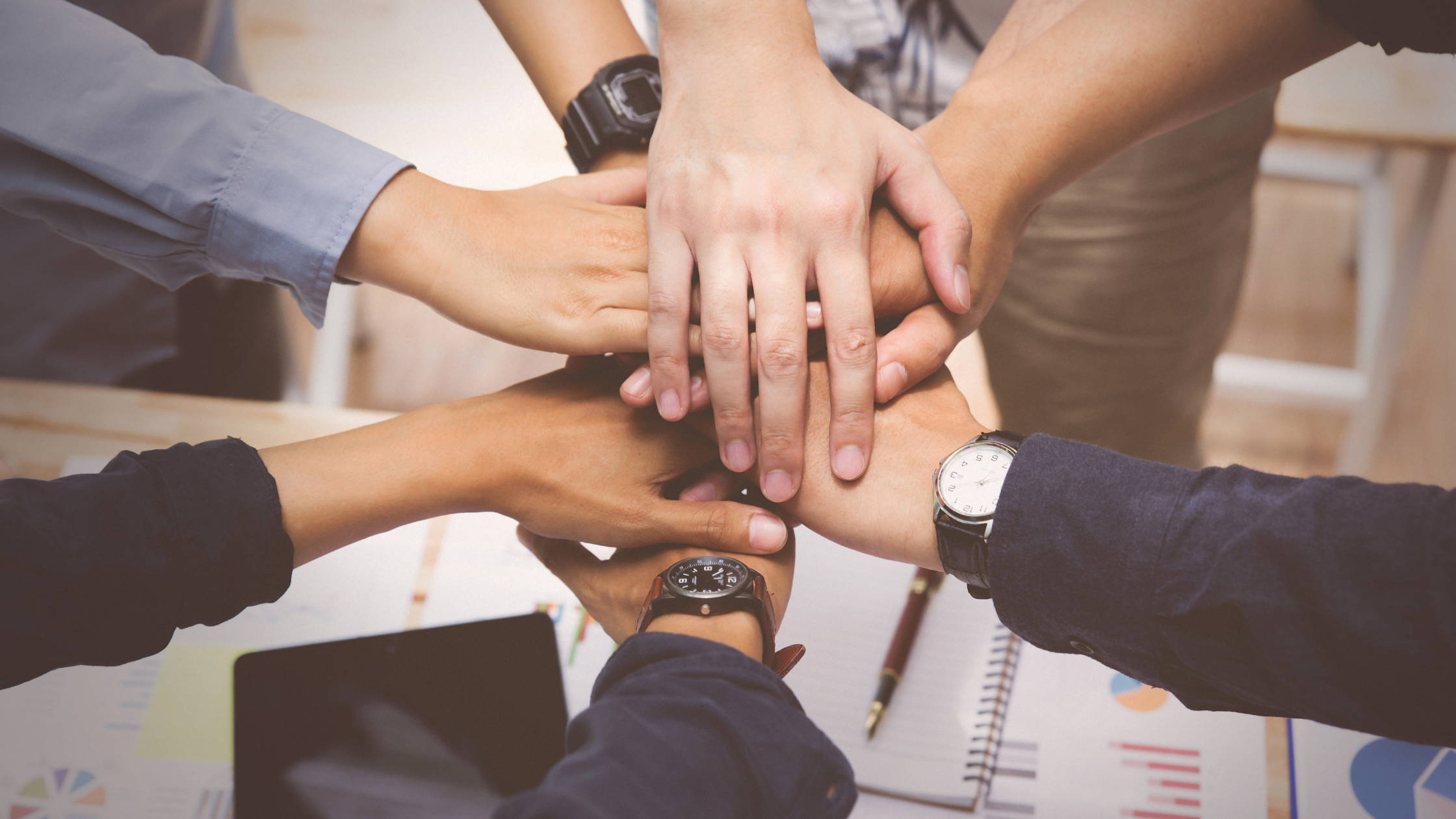 group of hands in a huddle