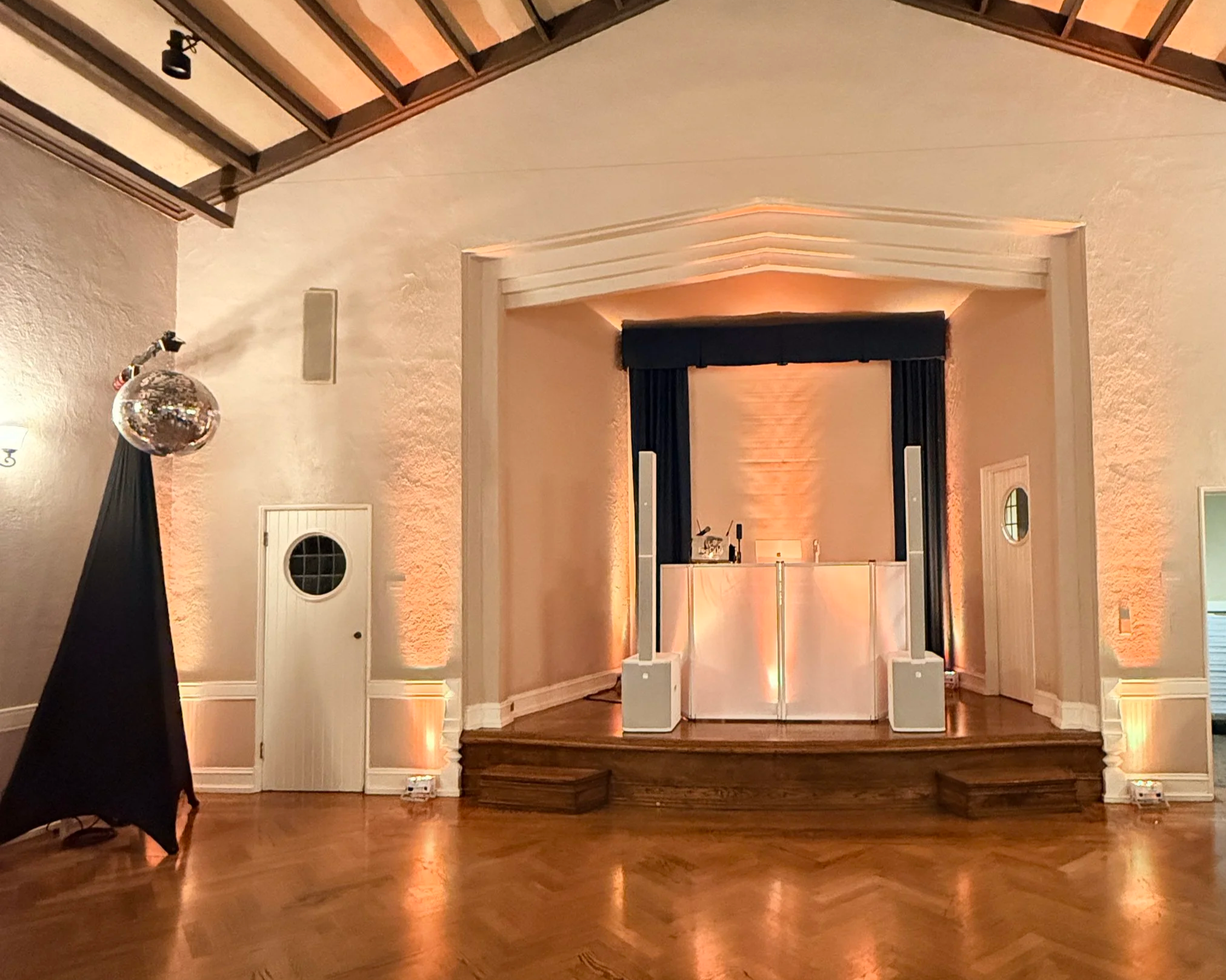 Gold Country DJ booth with vibrant disco-style lighting at a wedding reception.