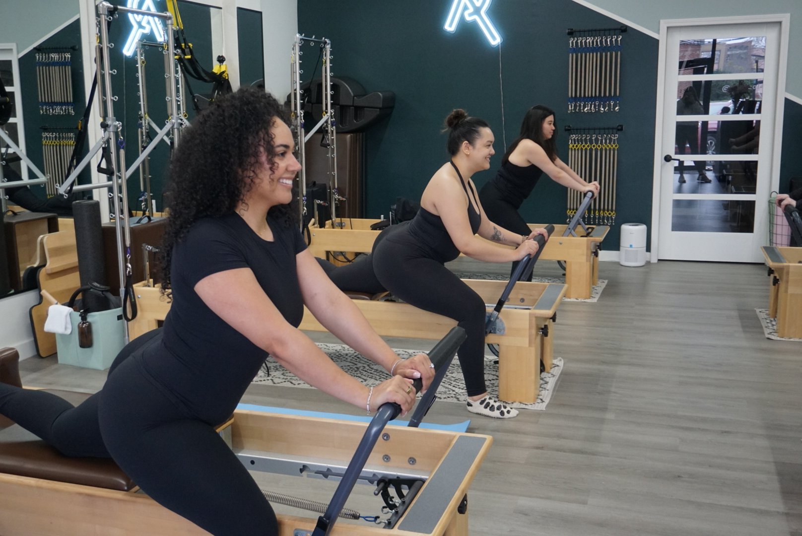 women stretching on Reformers