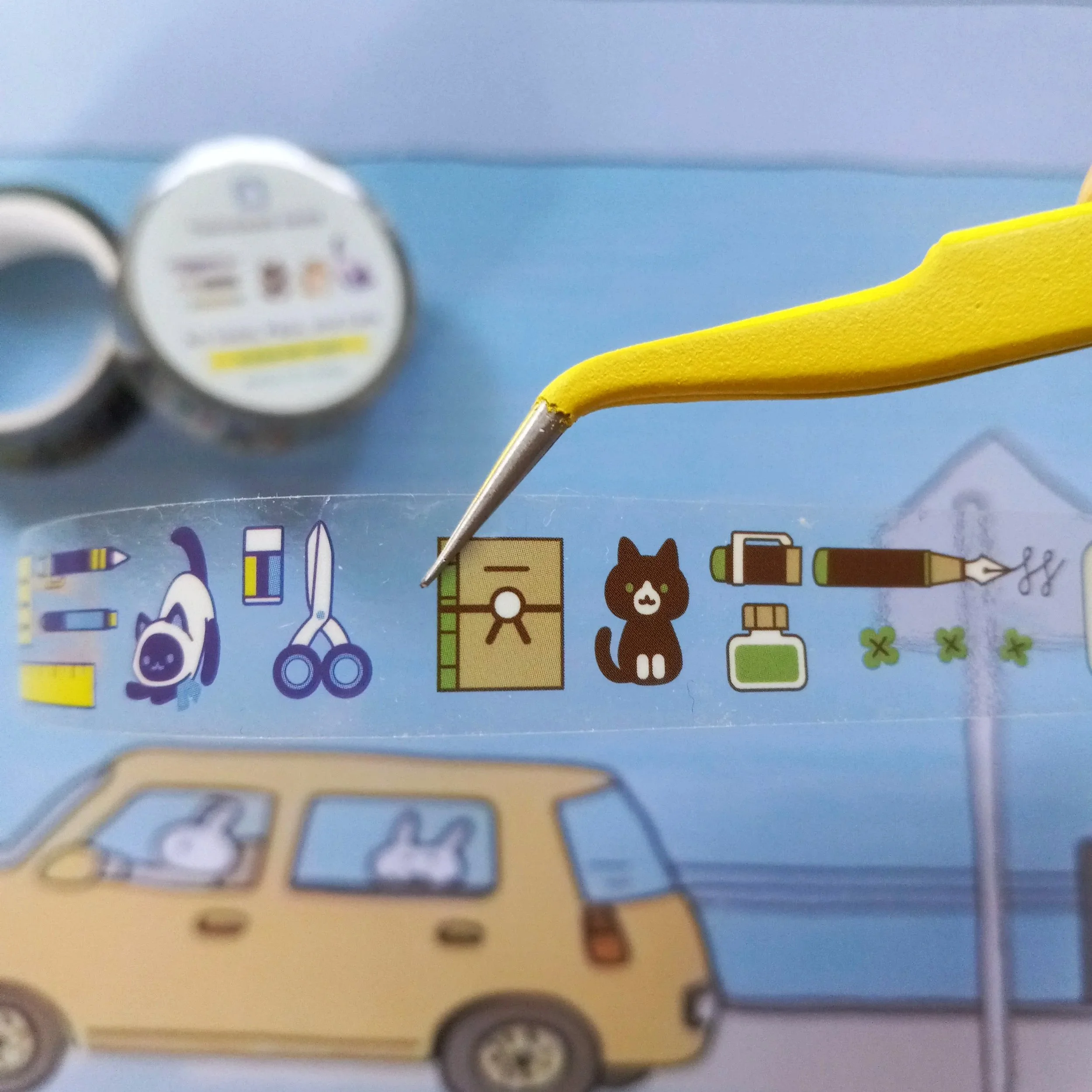 Whimsical stationery tape with cats and art supplies illustration
