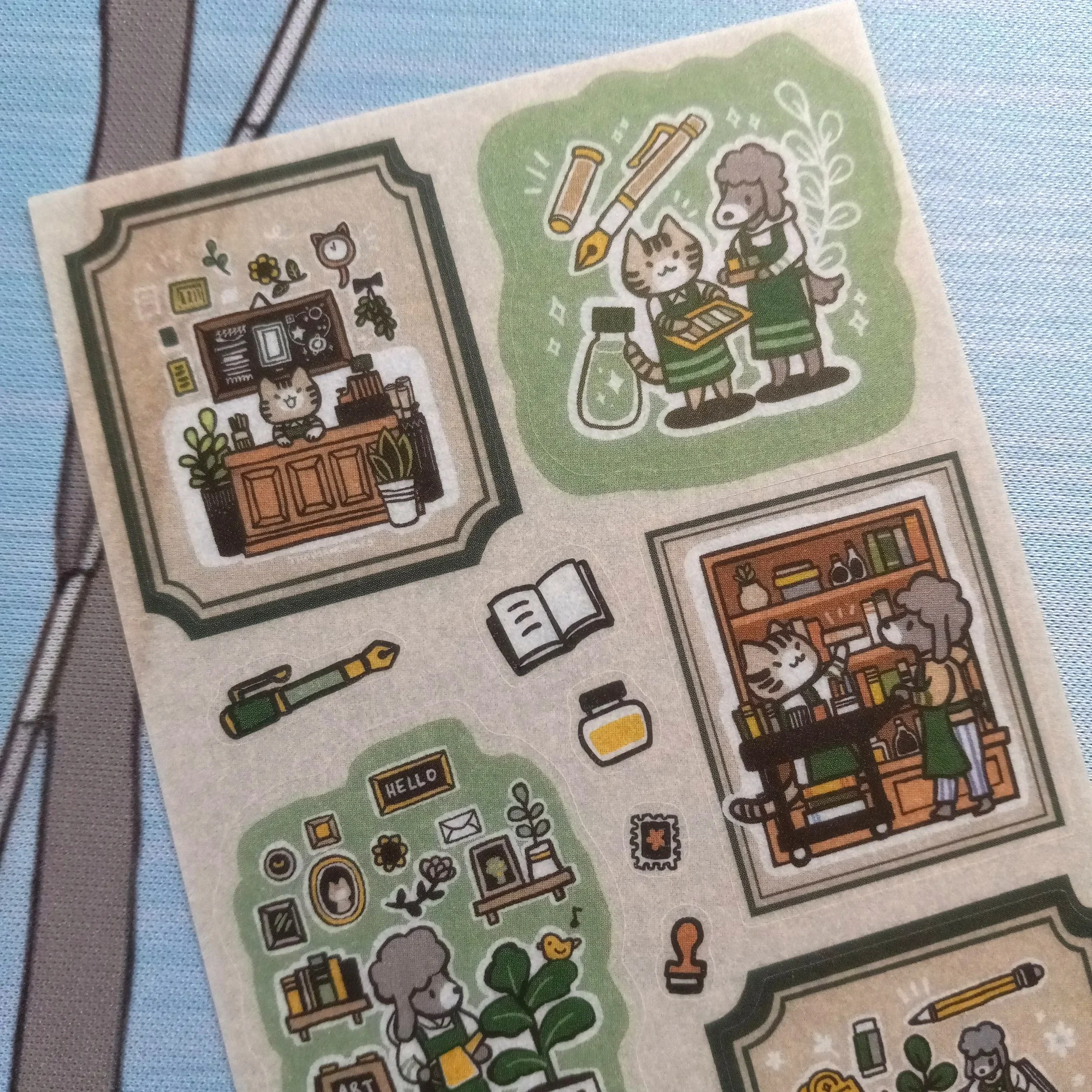 Close-up of “Stationery Store” washi sticker sheet showing cats and dogs running a stationery store with detailed illustrations