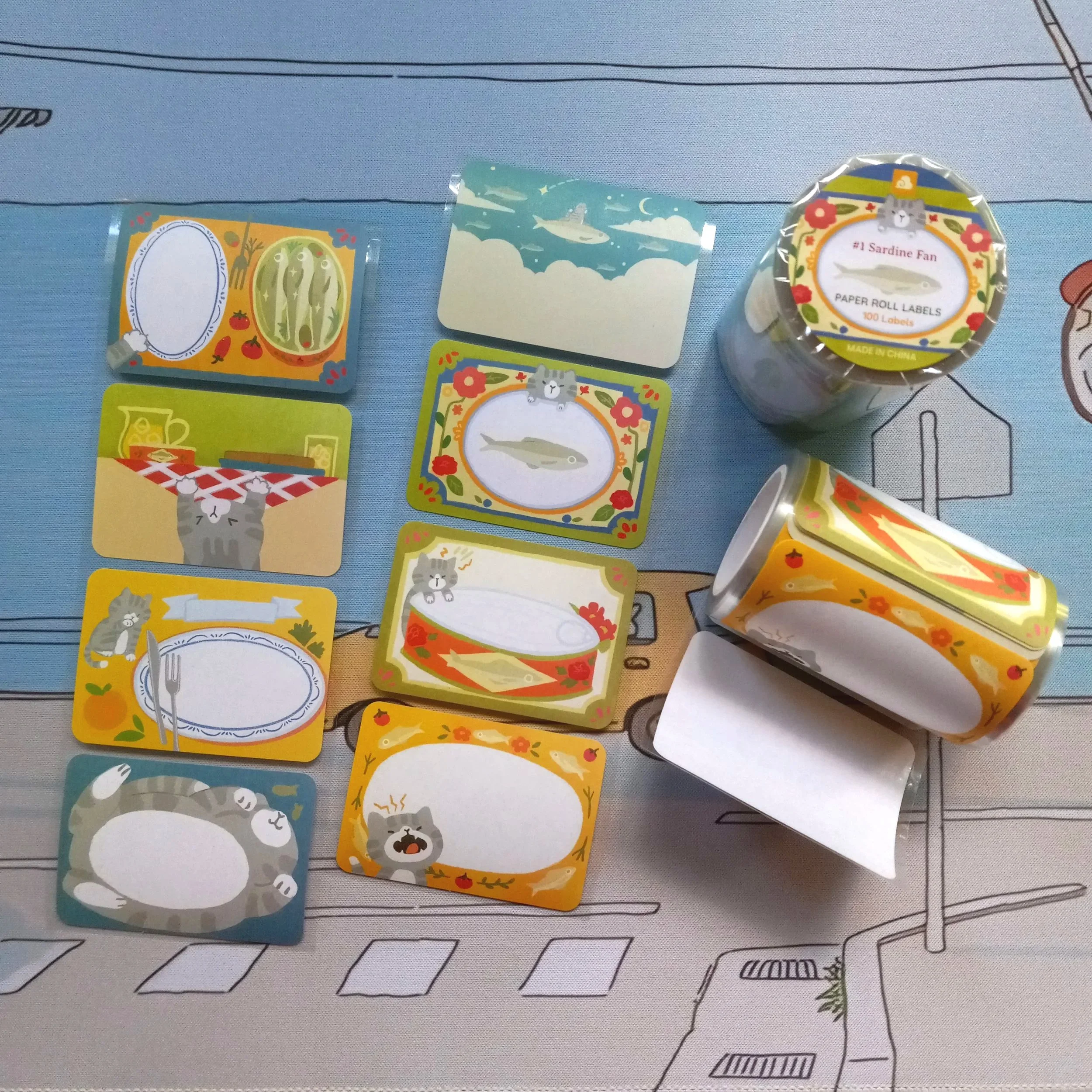 Paper roll label “#1 Sardine Fan” by Thousand Skies featuring illustrated cats with sardines
