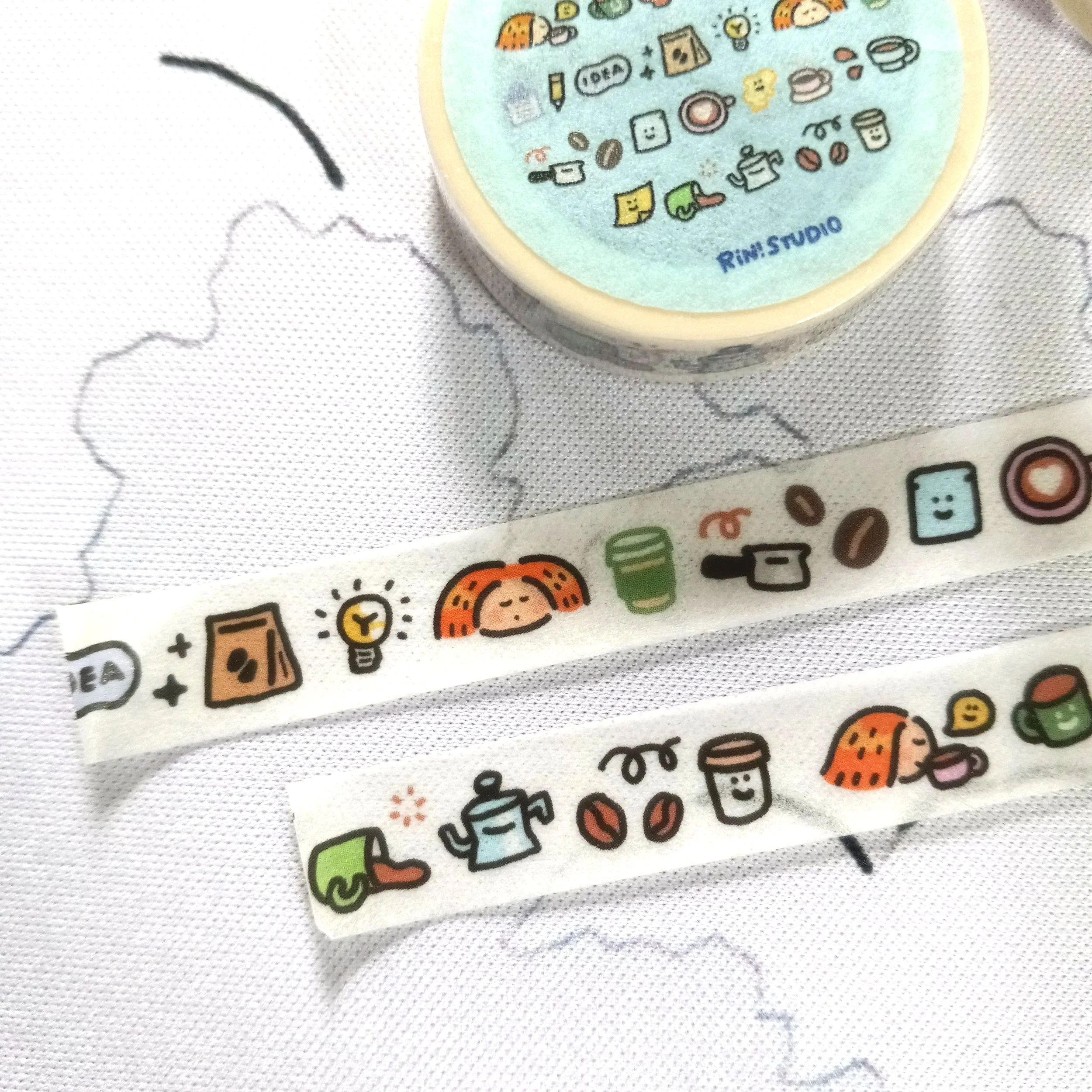 Decorative mini washi tape roll featuring adorable coffee cups, emojis, and kawaii-style illustrations by RiN! Studio