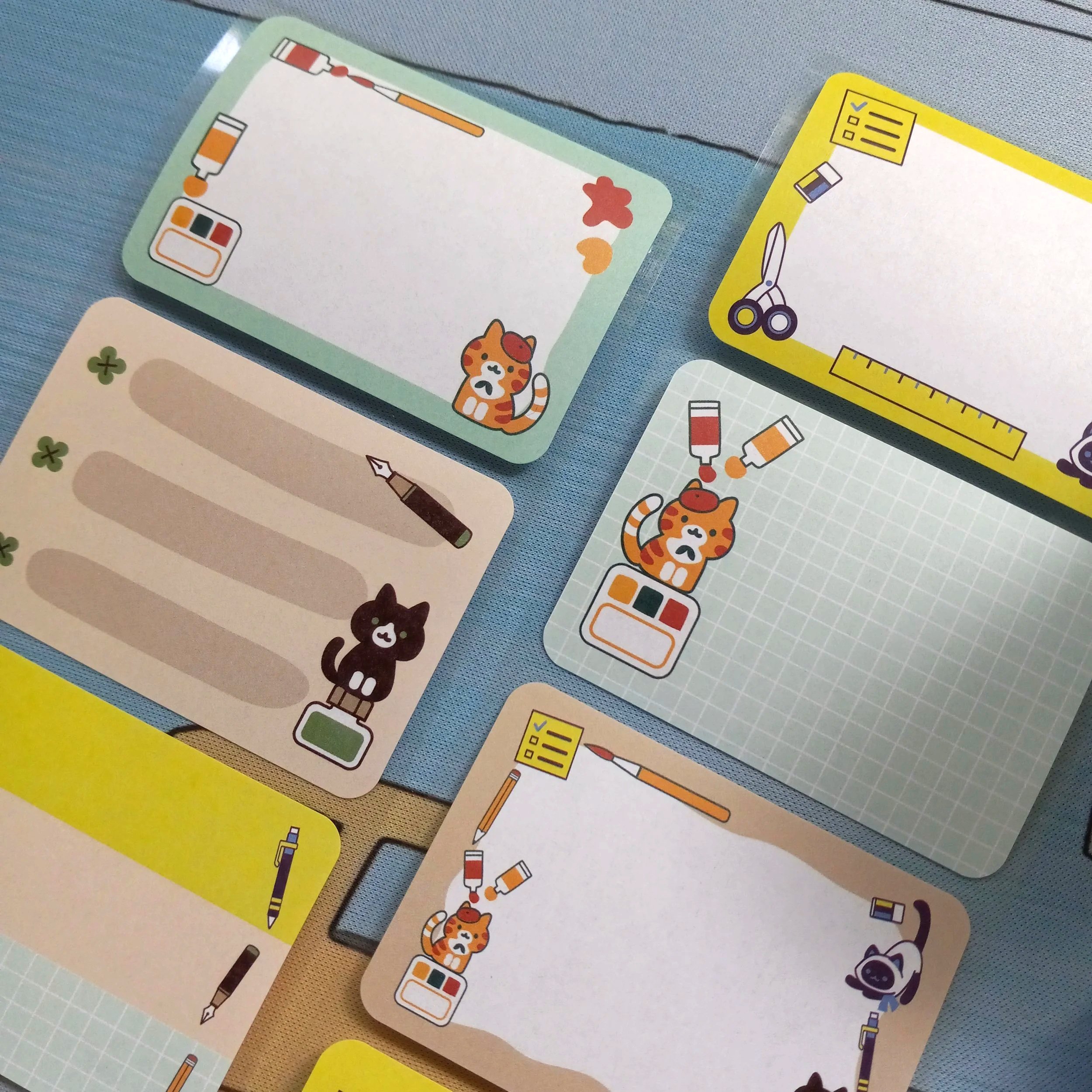 Detailed close-up of “Stationery Cats” label roll with repeating cat and stationery themed illustrations