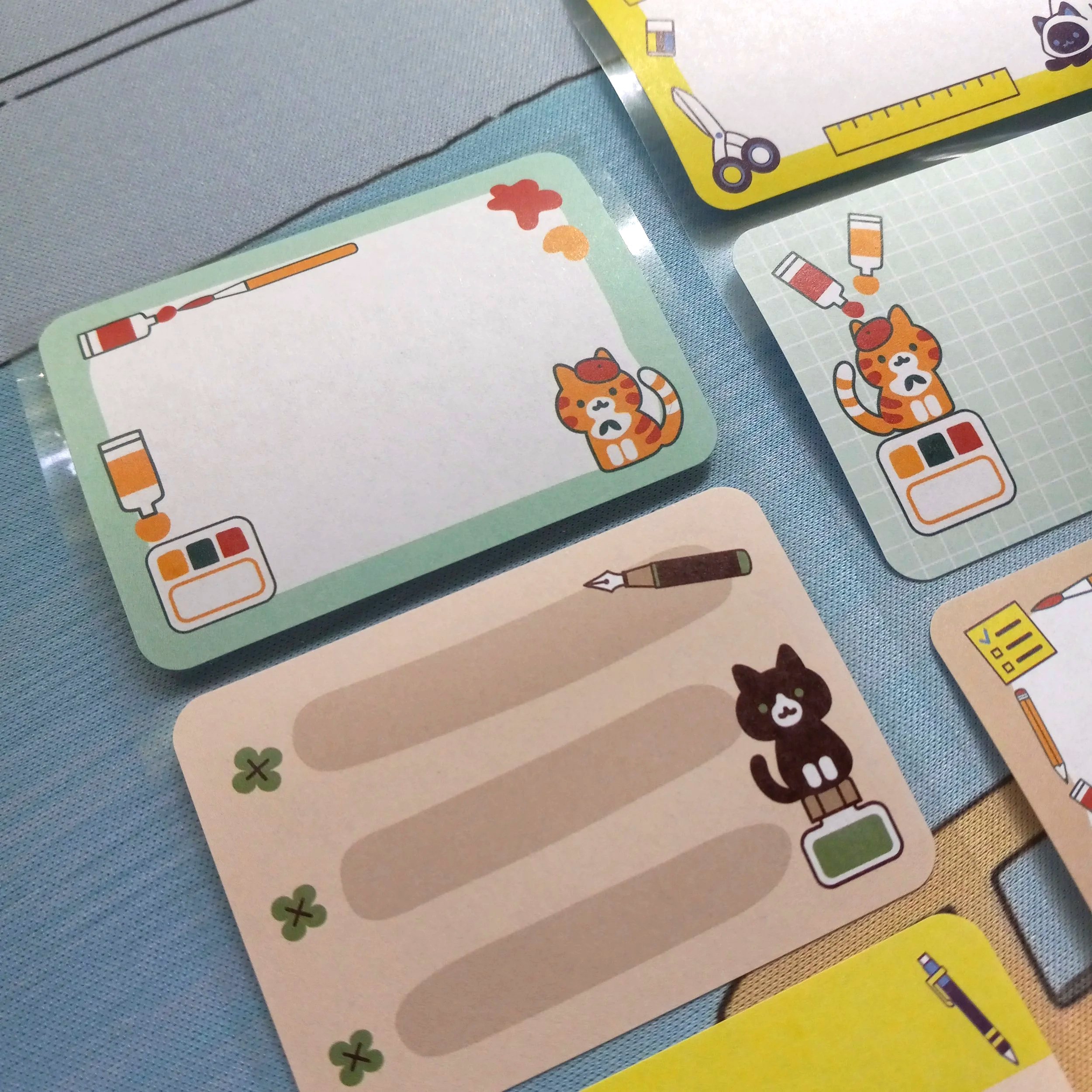 Macro view of Thousand Skies “Stationery Cats” label roll showing repeating cat and stationery themed designs