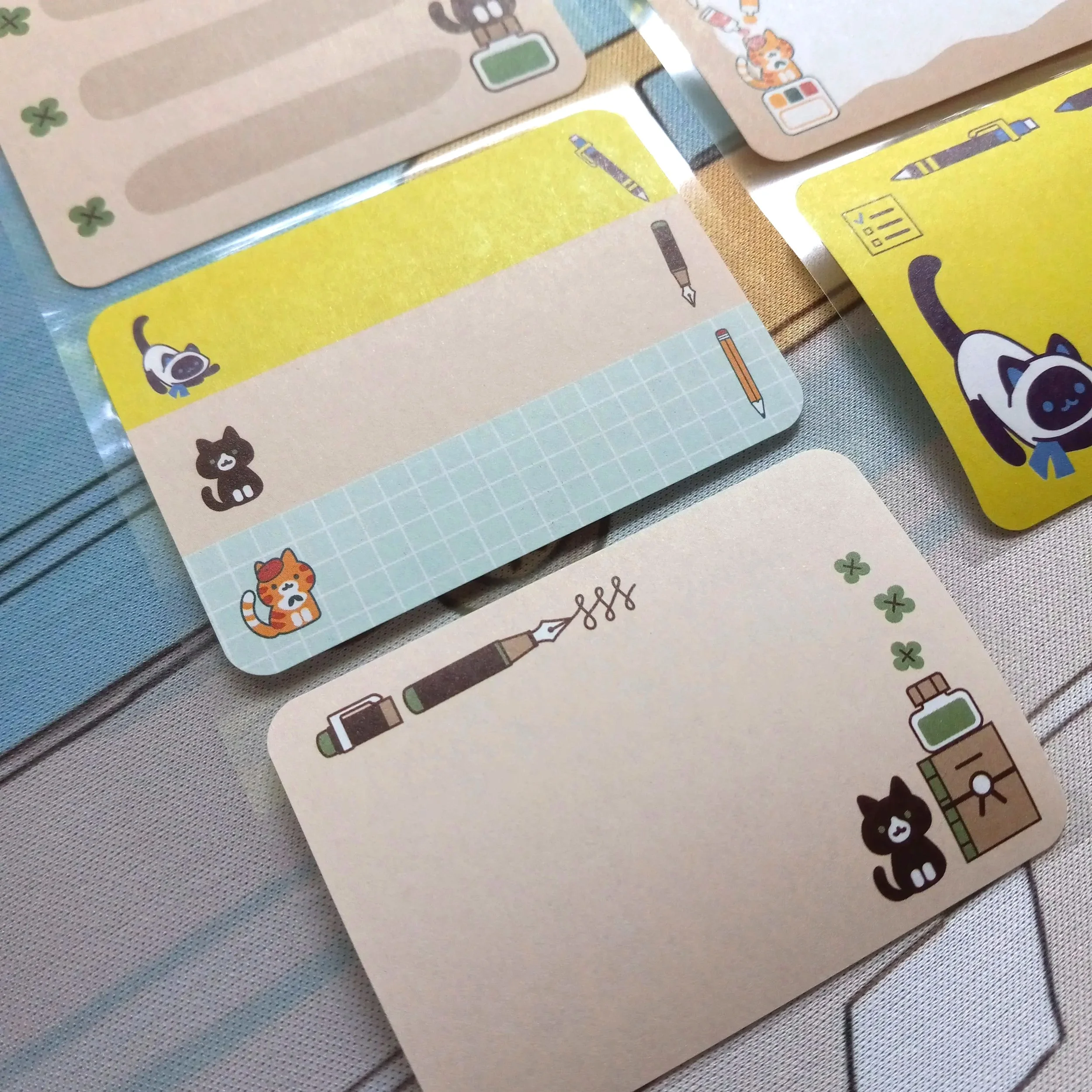Detailed close-up of paper roll labels “Stationery Cats” with whimsical cat illustrations and stationery elements