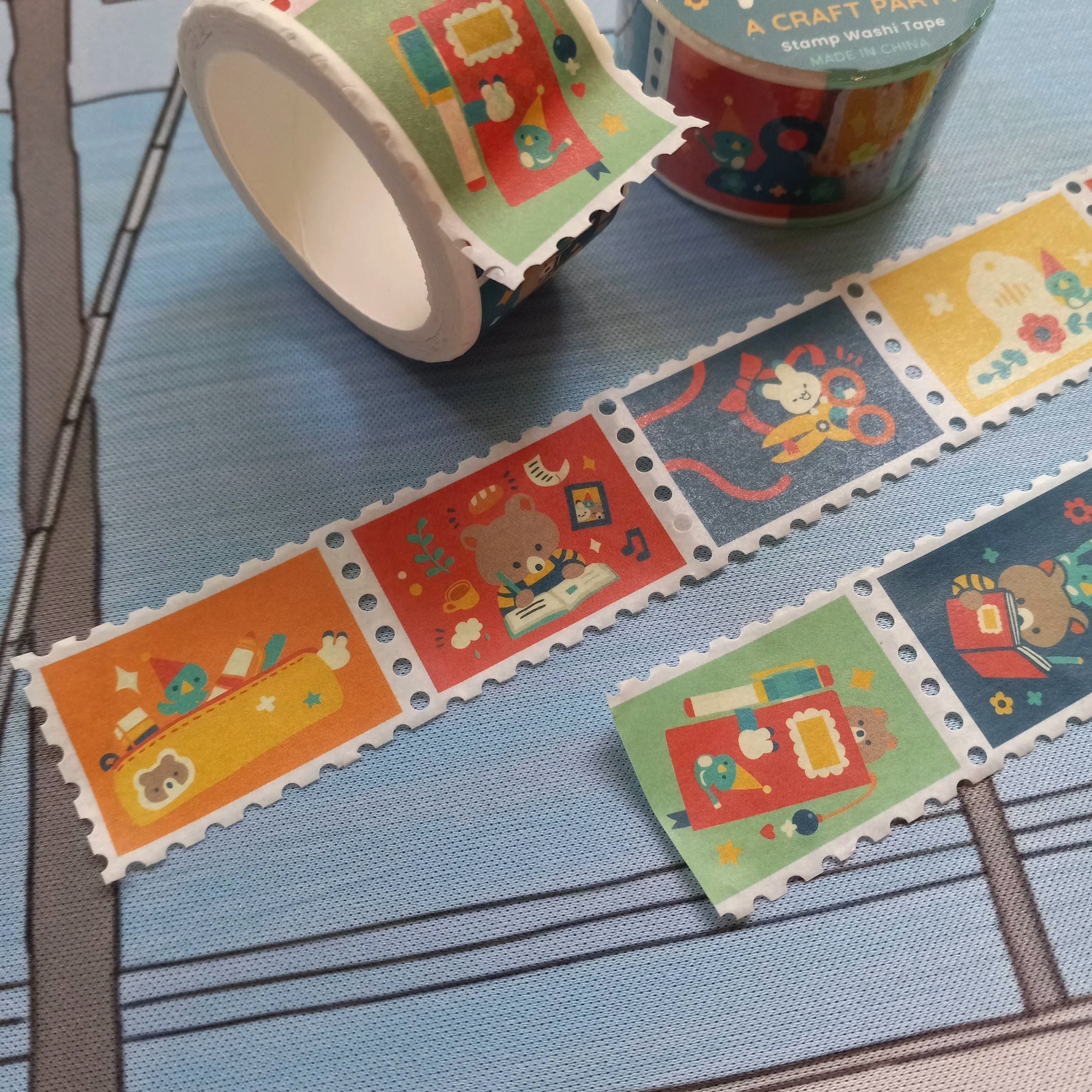 Close-up of stamp washi tape showing “A Craft Party” illustrated designs on a continuous decorative strip