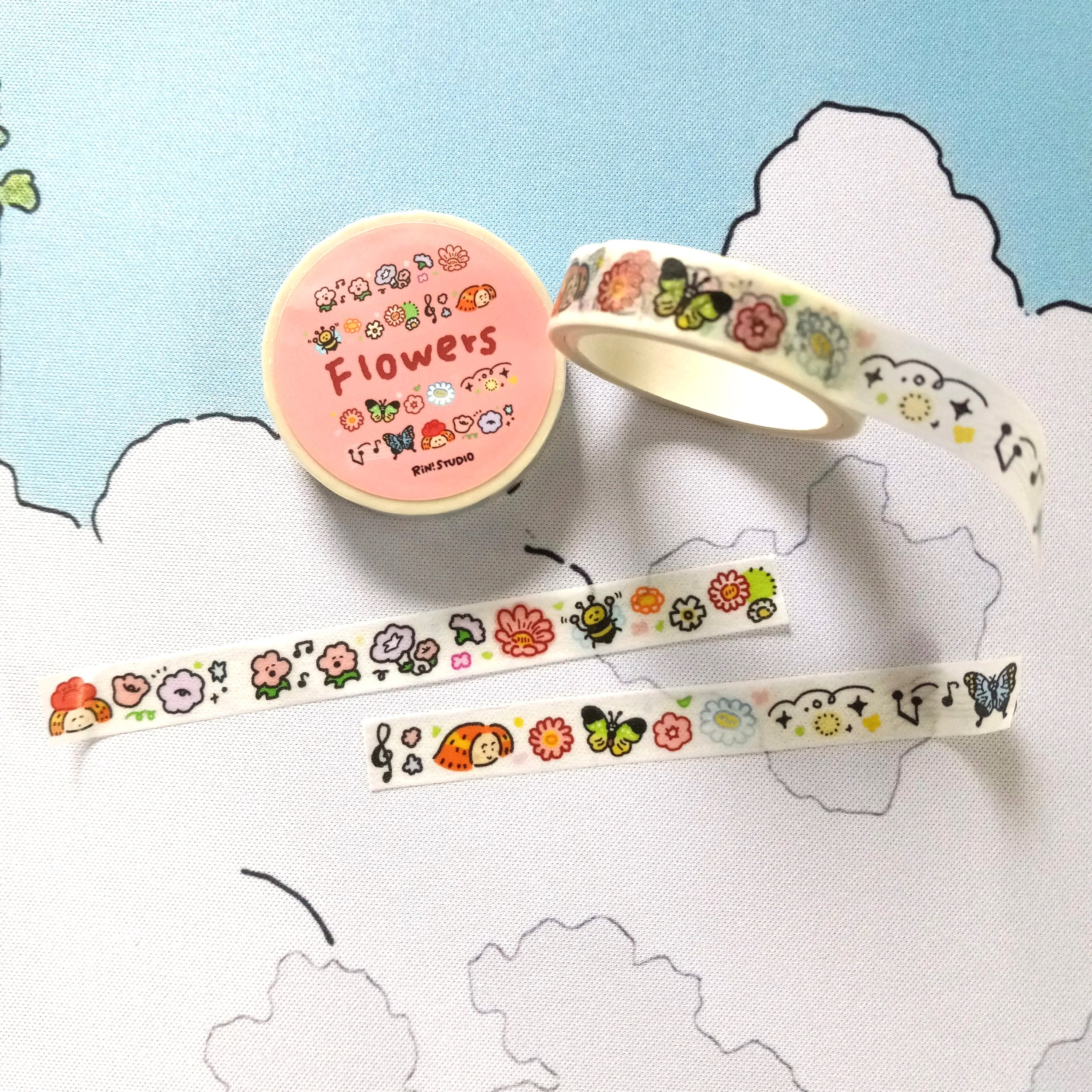 Mini washi tape roll showcasing bright, playful flower artwork in a whimsical illustrated style by RiN! Studio