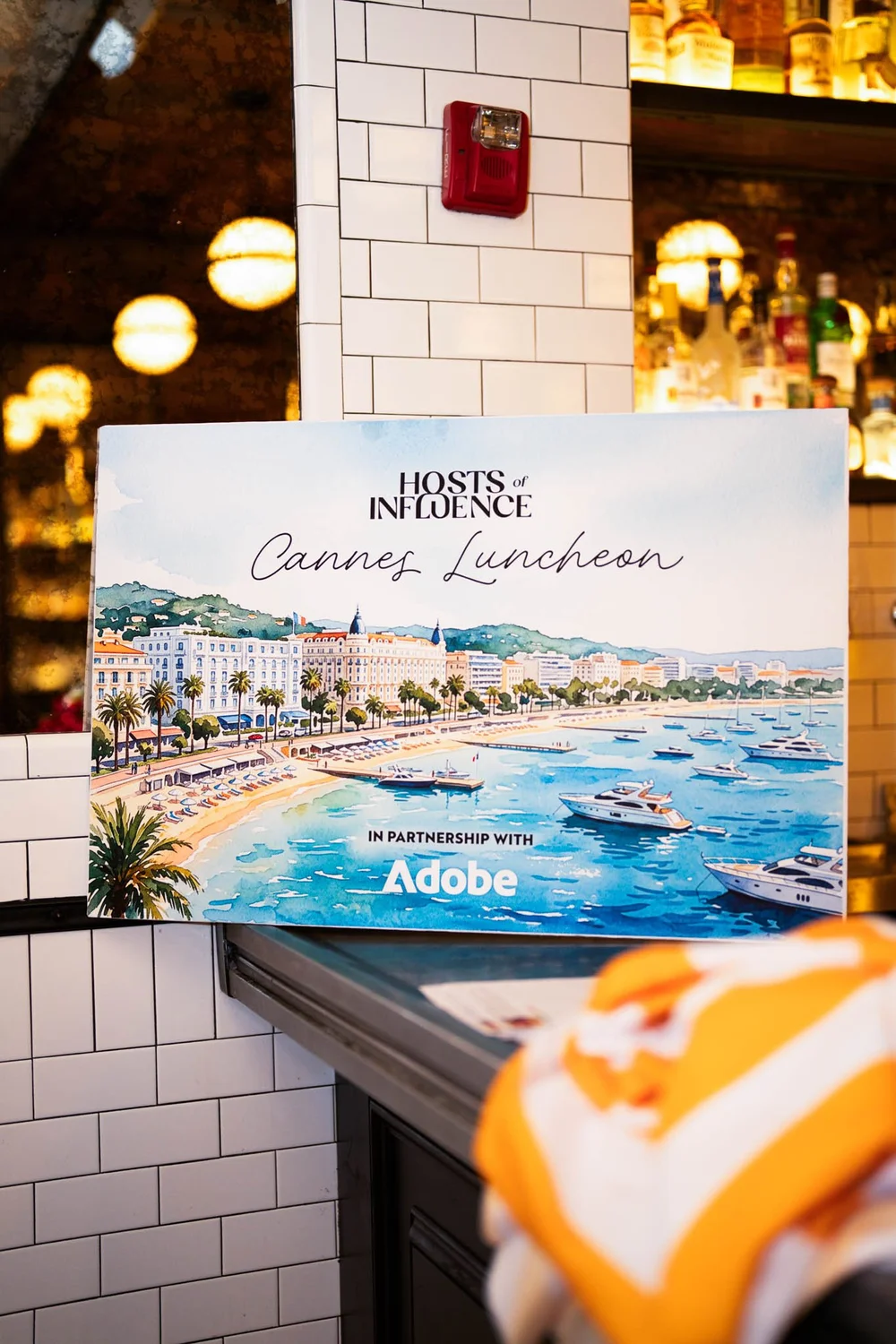 Cannes Luncheon signage featuring Hosts of Influence in partnership with Adobe
