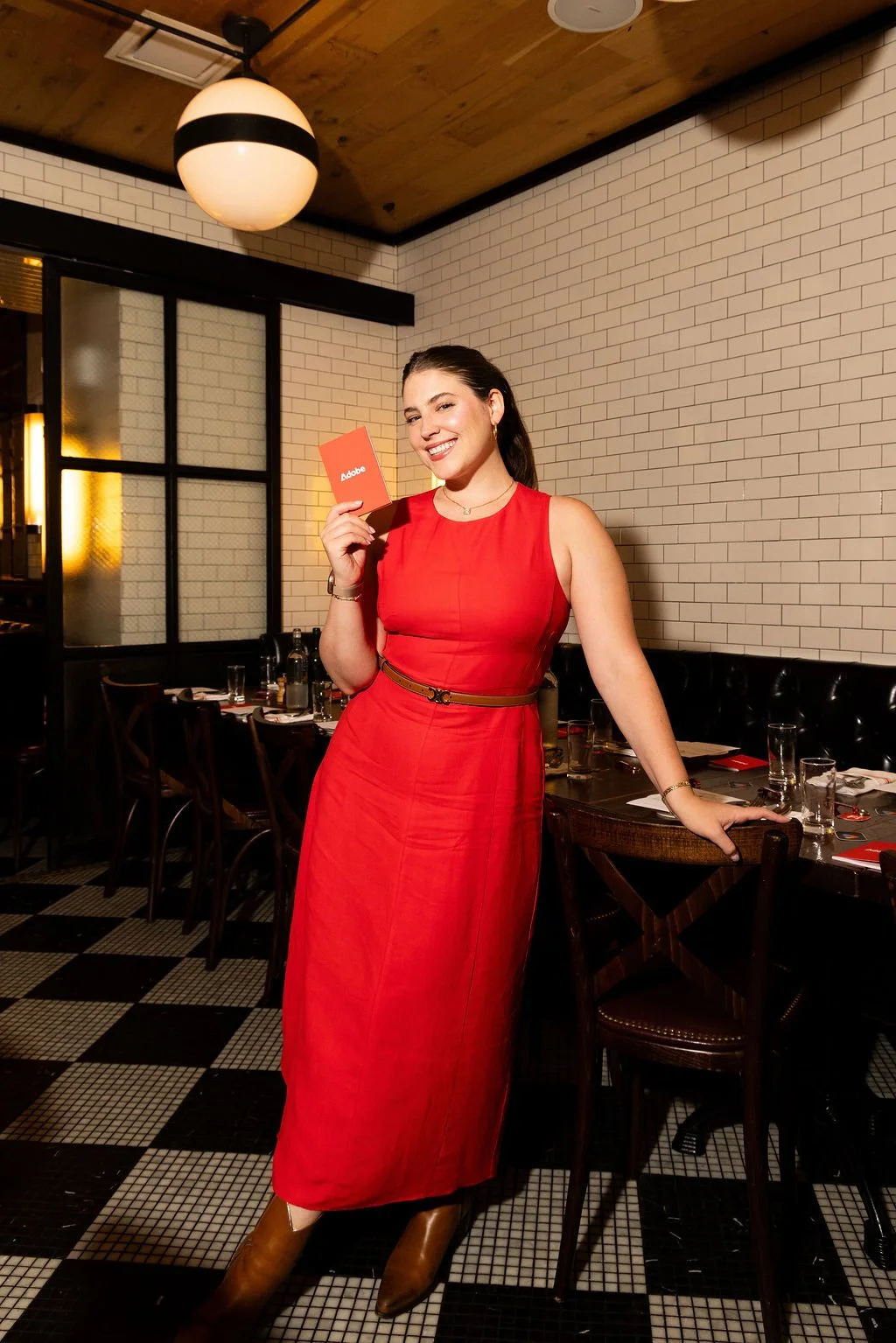 Gigi Robinson hosting an event in a red dress