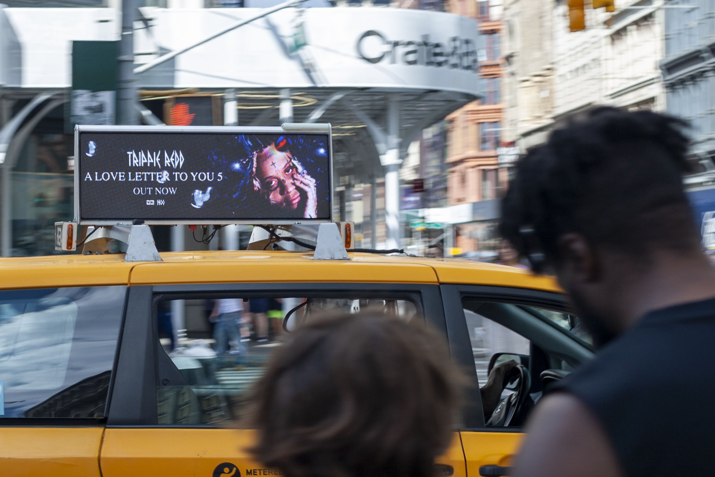Taxi digital top display in busy New York street